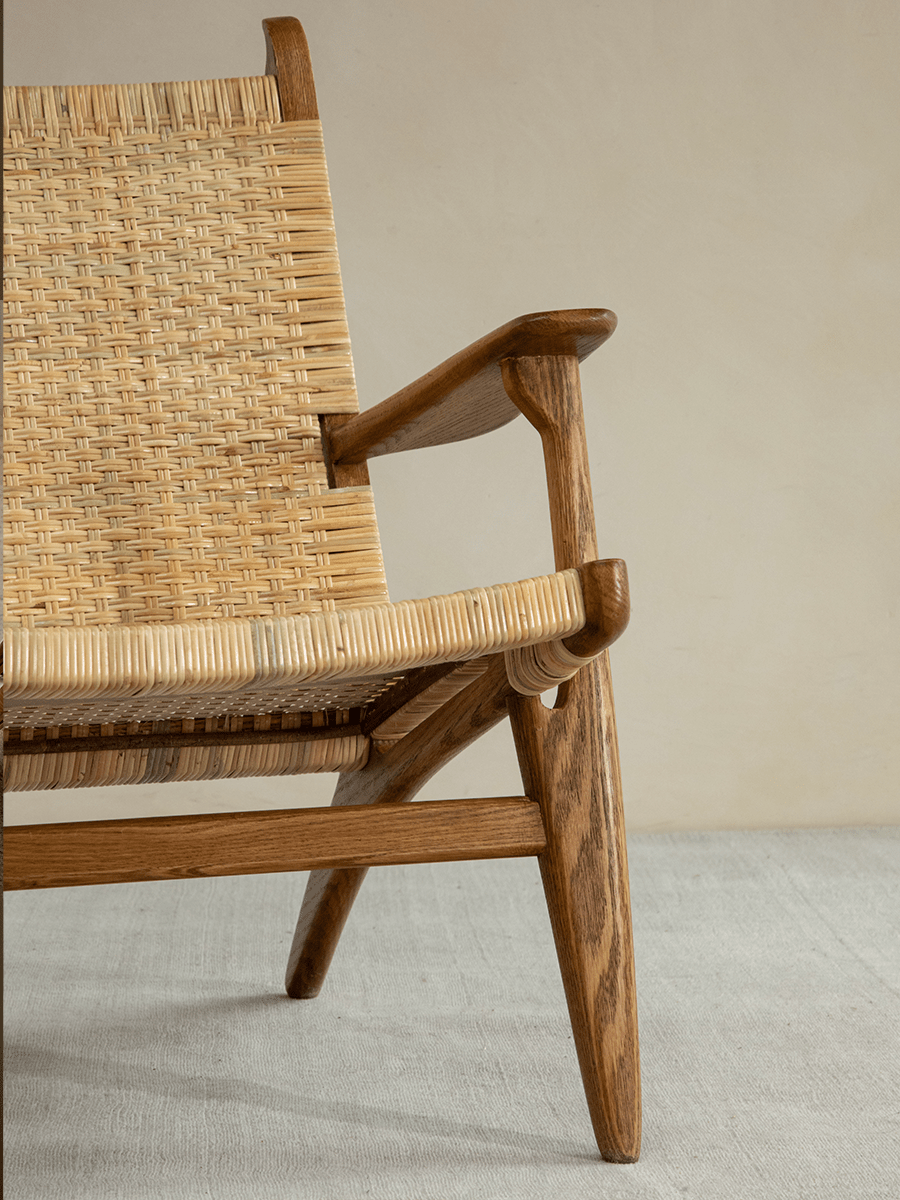 Horn Lounge Chair with oak frame and natural rattan, ergonomic design. Handcrafted for interior decor.