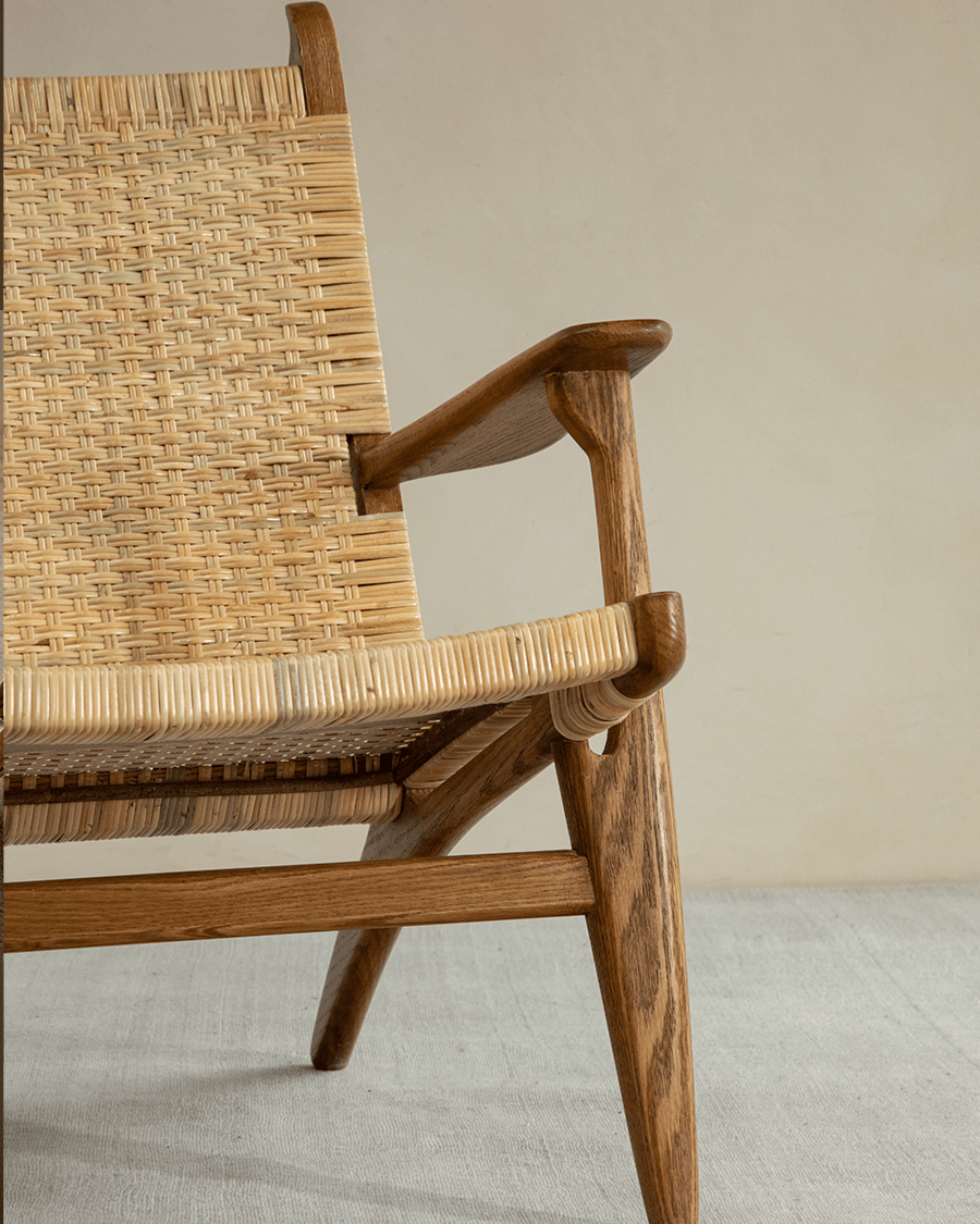 Horn Lounge Chair with oak frame and natural rattan, ergonomic design. Handcrafted for interior decor.