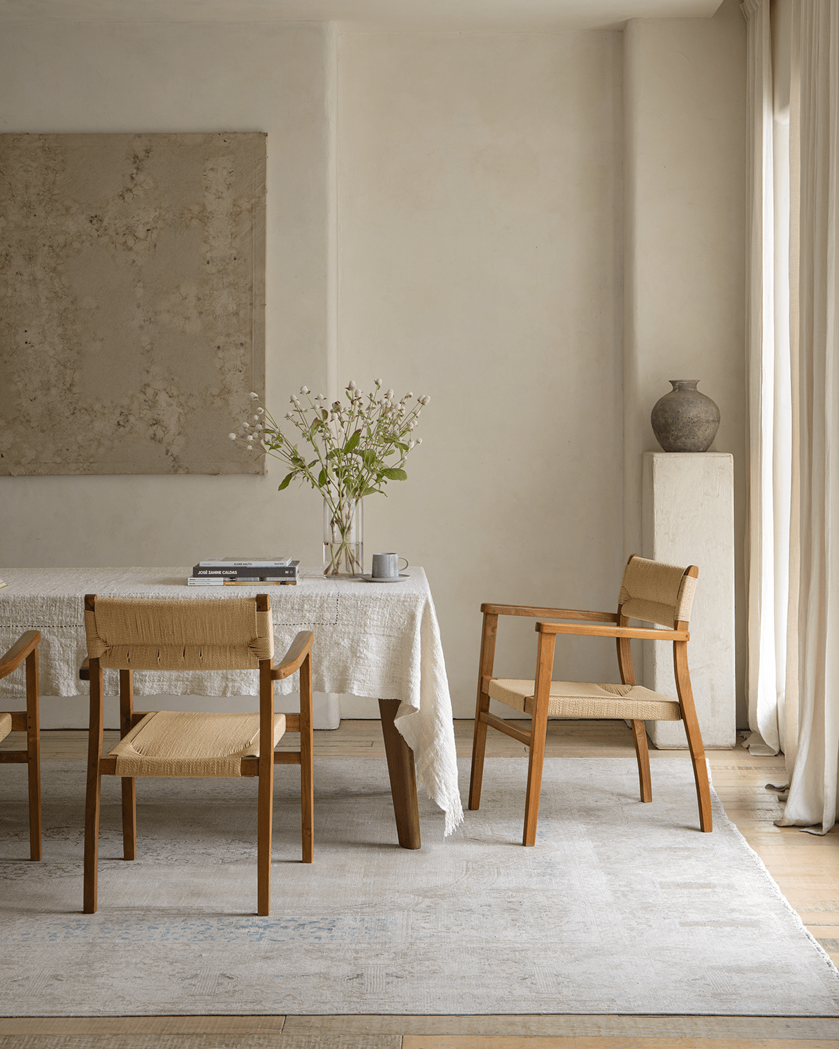 Reed Chair in dining room setting, teak frame and woven seat, elegant and comfortable design