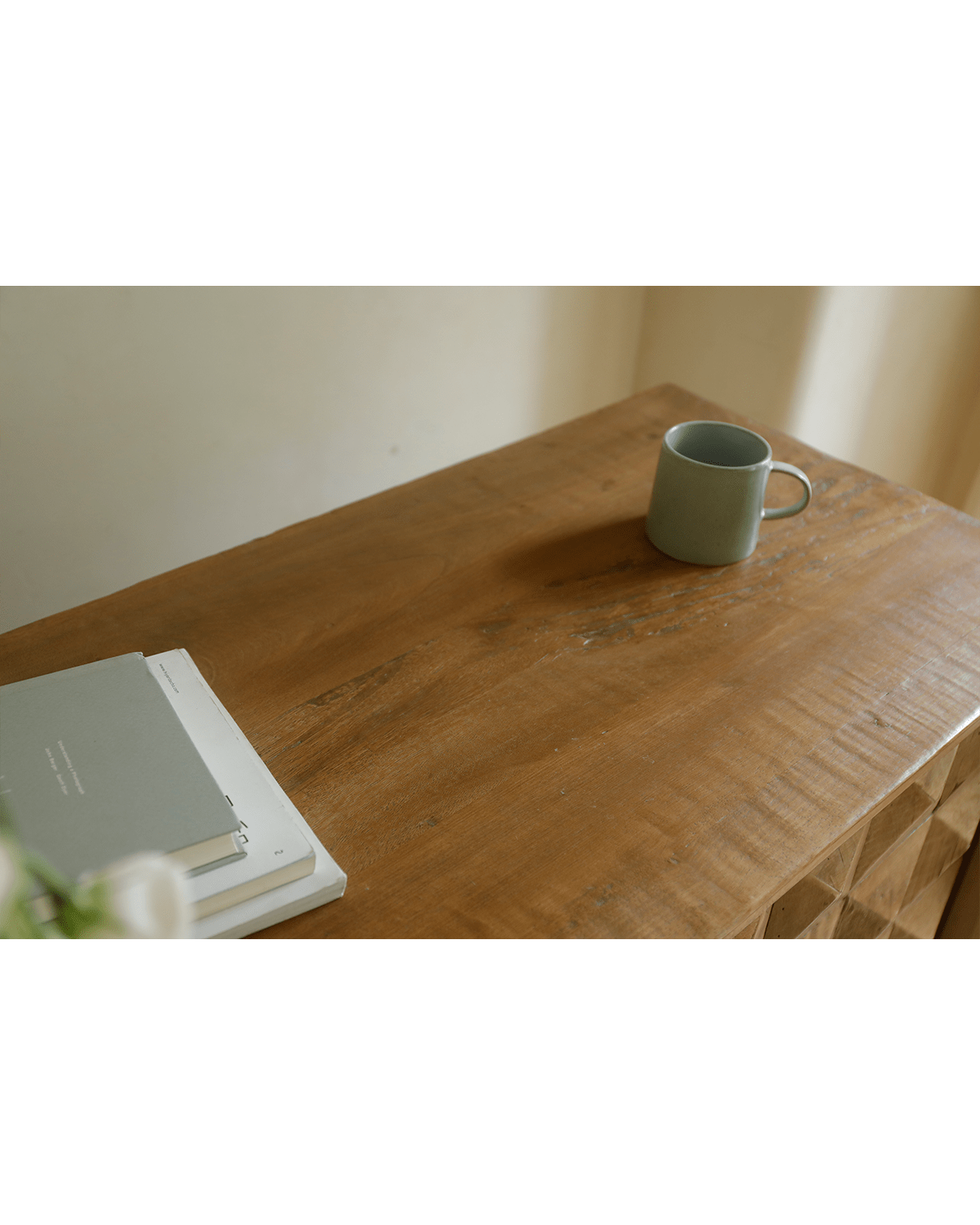 Bumpy Sideboard with reclaimed wood, books and mug, perfect for modern living room decor