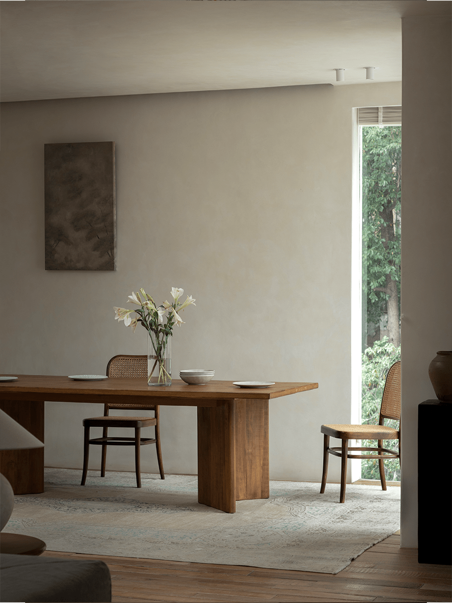 Zephyr Dining Table in a styled interior with matching chairs and decor, featuring natural wood and minimalist design.