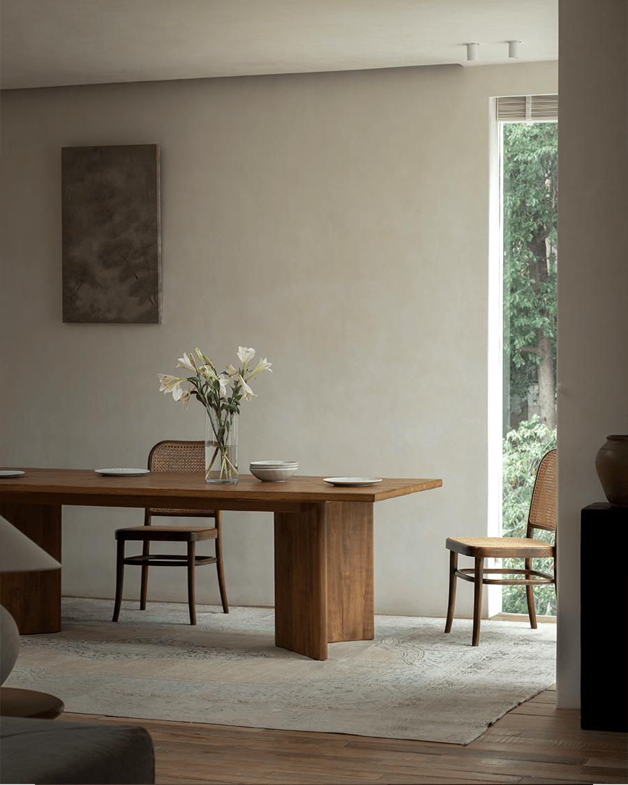 Zephyr Dining Table in a styled interior with matching chairs and decor, featuring natural wood and minimalist design.