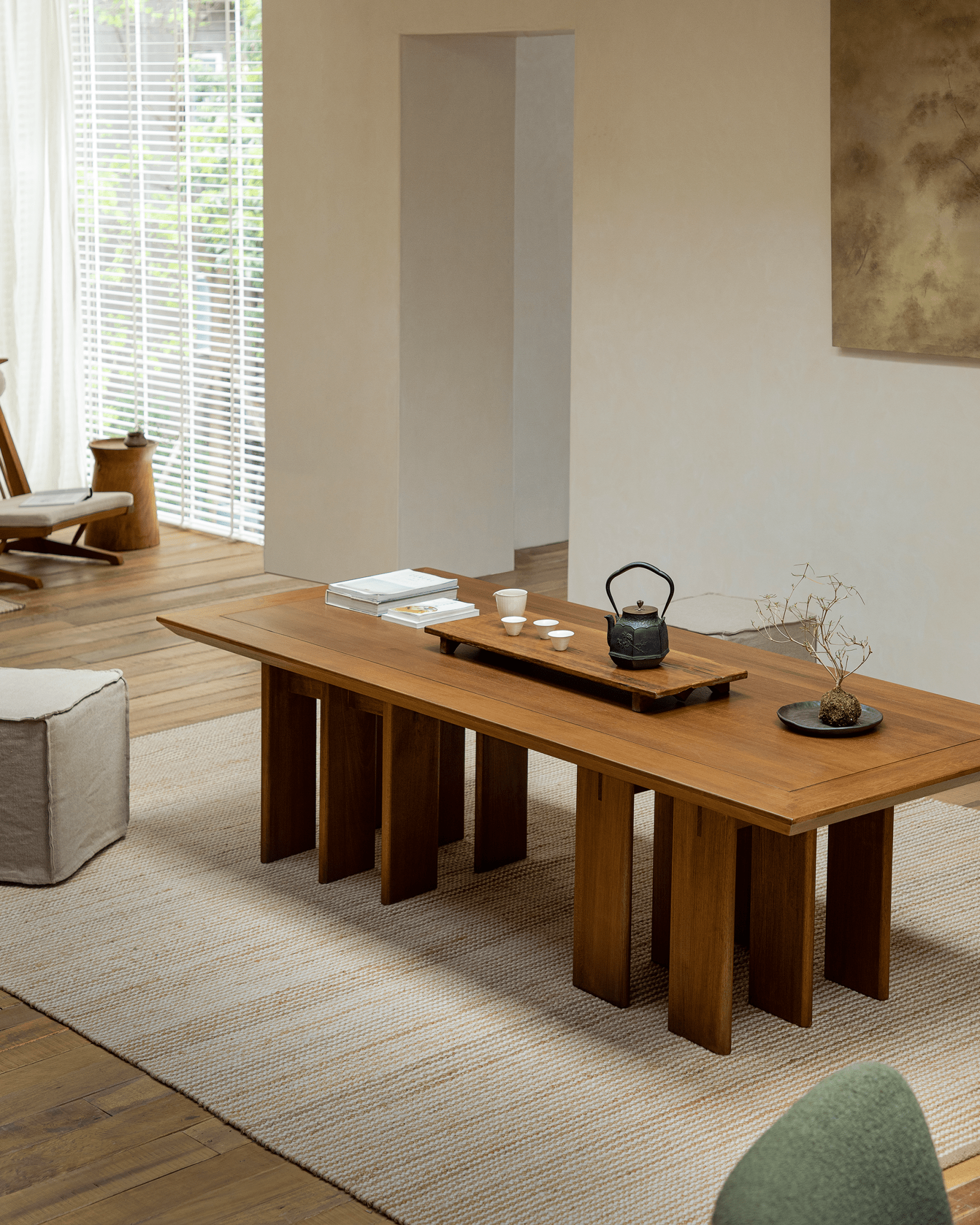 Titan Teak Dining Table in a modern dining room setting with tea set, natural light, and multi-leg design.