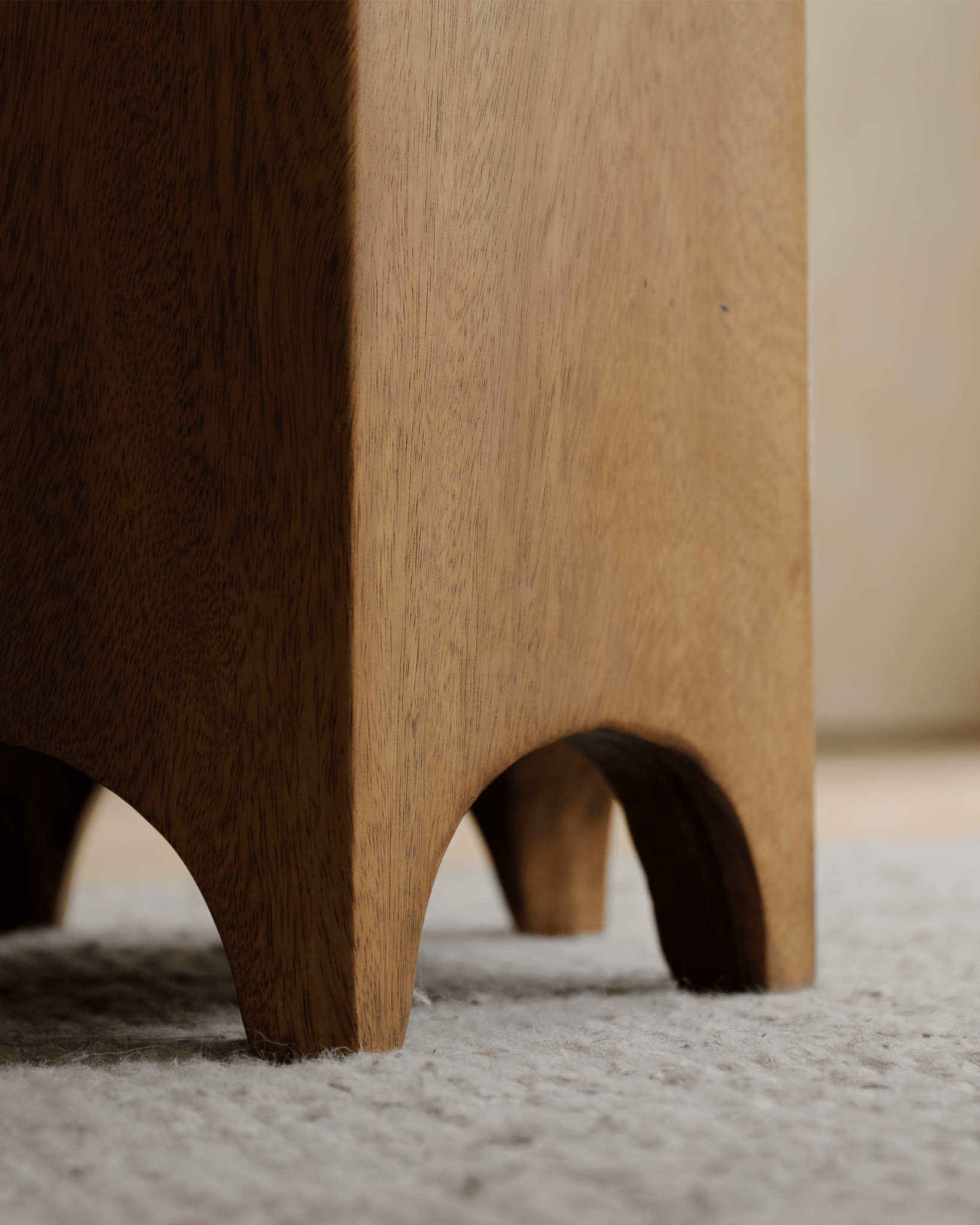 Close-up of Hexagon Side Table legs, showcasing the natural wood grain and curved design, perfect accent piece.