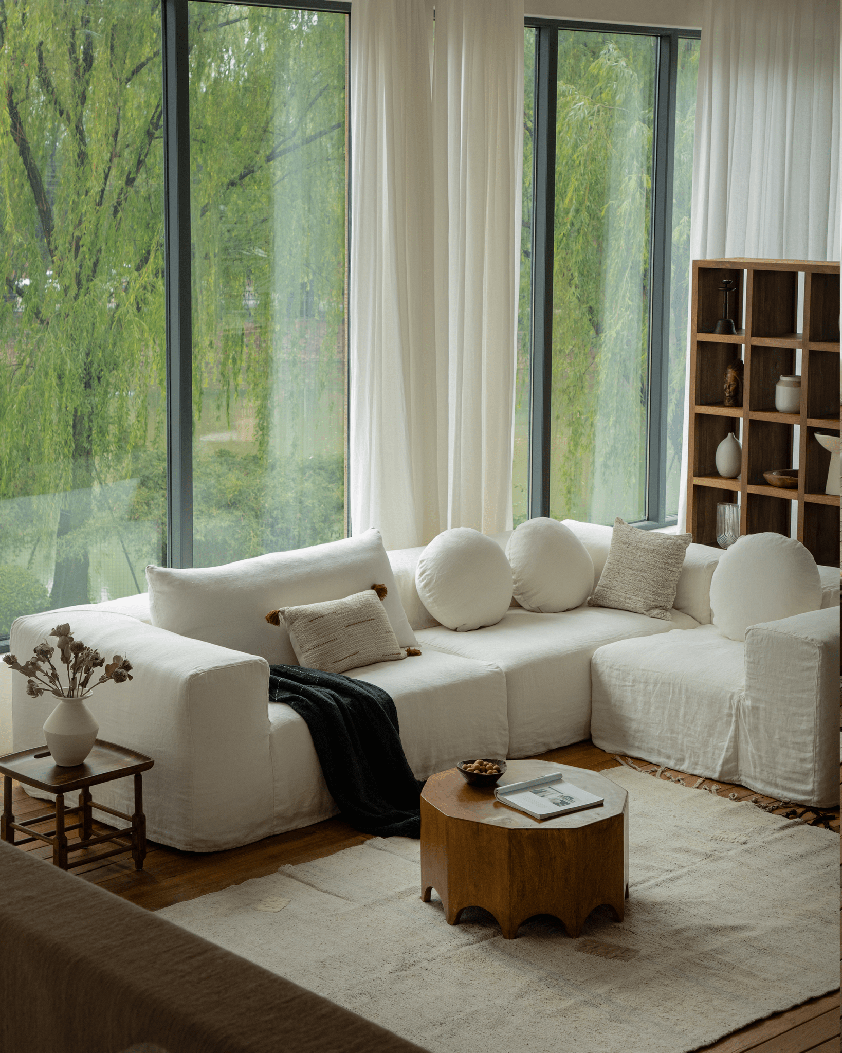 Doma Sectional Sofa in white linen, modular design, in a bright living space with wide armrests