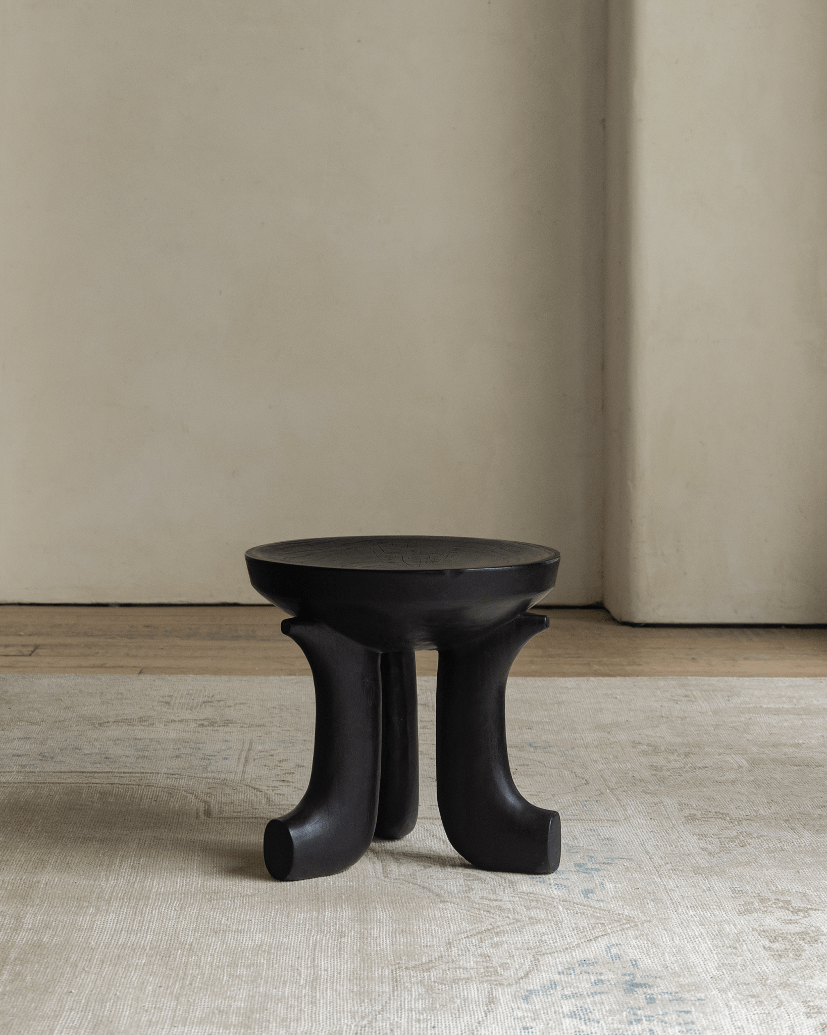 Quincy Stool, black wooden three-legged design, modern home decor