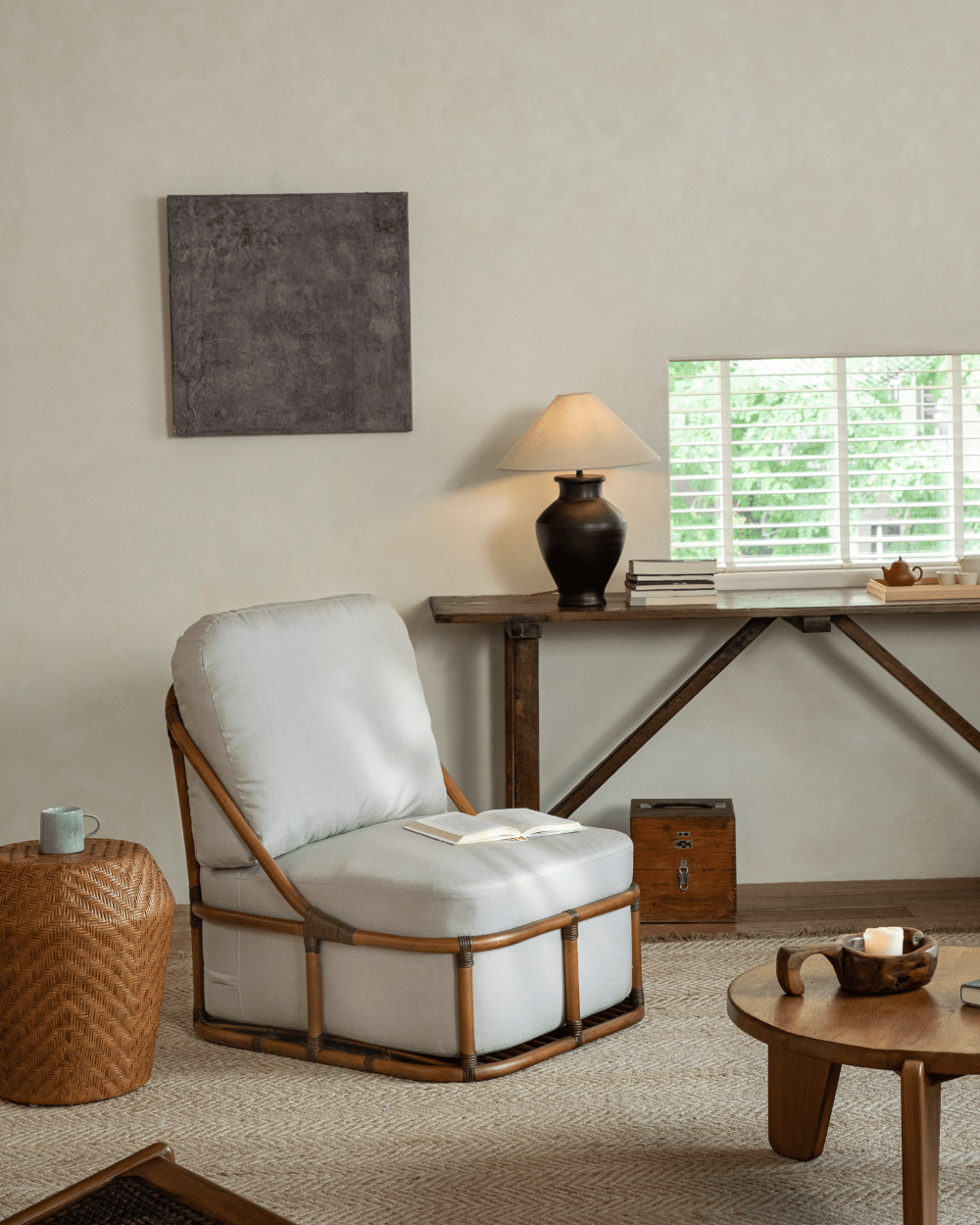 Tofu Lounge Sofa in a relaxed living room setting. Natural rattan frame and light gray cushion.