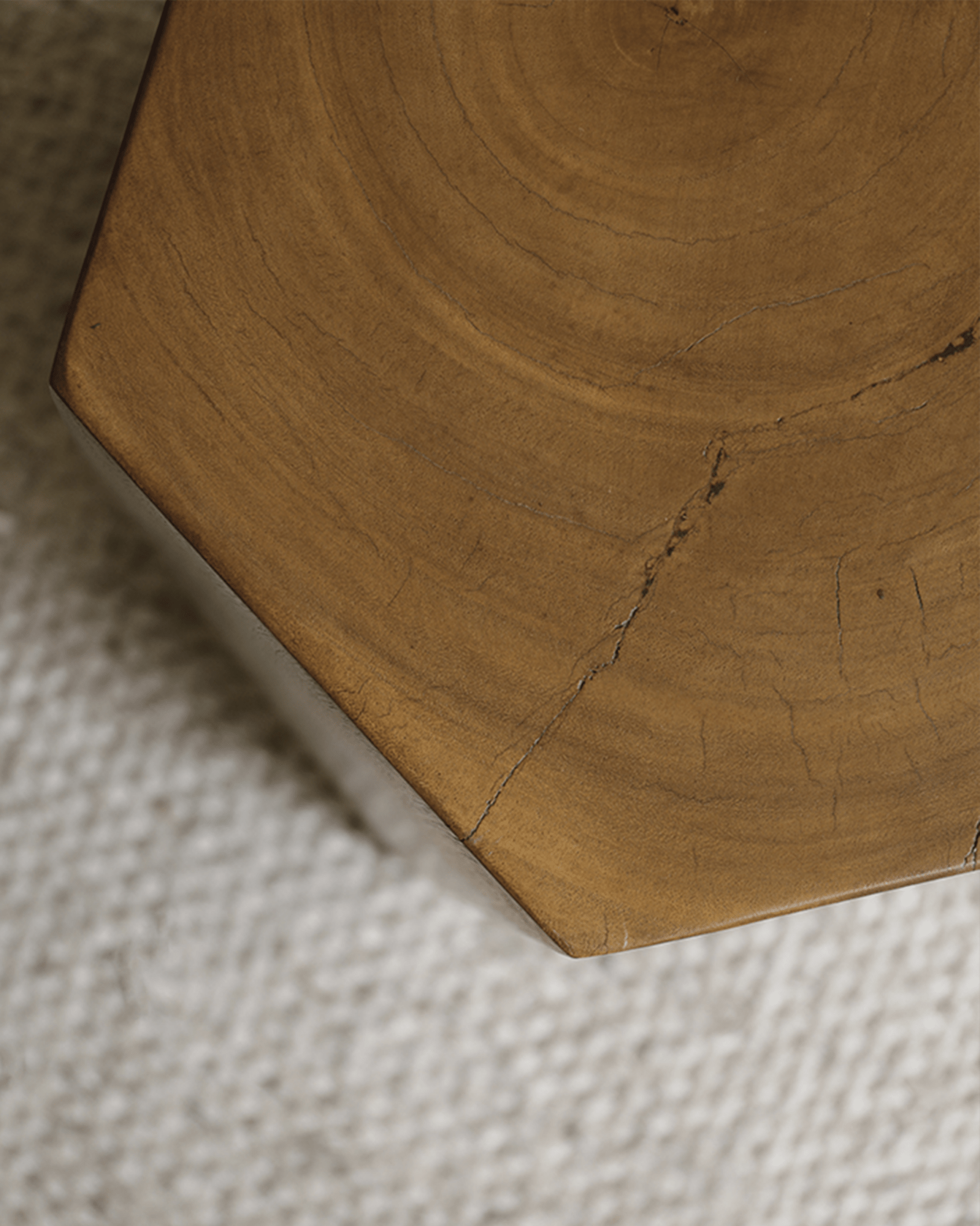 Close-up of the hexagonal side table's natural wood grain, highlighting its texture and geometric design.