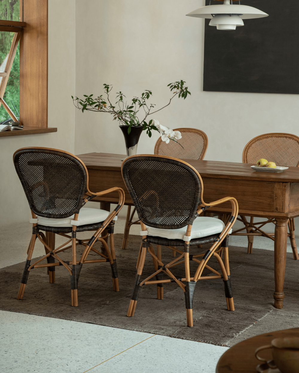Areca Rattan Dining Chairs with White Cushions, Handwoven Rattan Backrests, and Wooden Table, Natural Comfort Design.