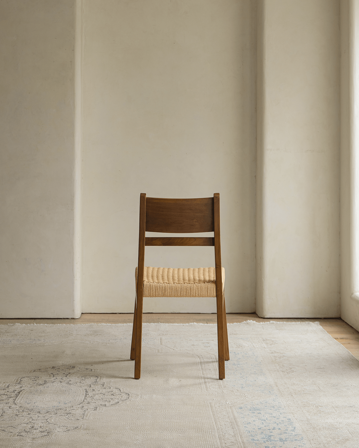 Beam Chair with teak wood frame and woven seat, showcasing vintage elegance and space-saving design