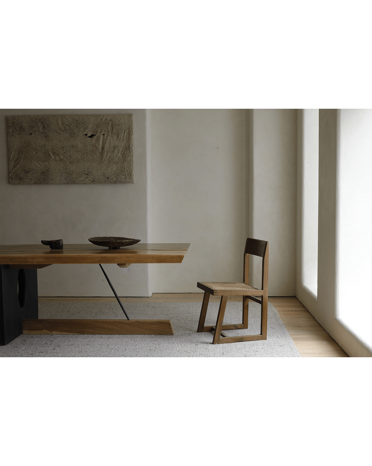 Chandigarh Box Chair in a modern interior with woven seat and wooden frame. Classic Mid-Century Modern Design