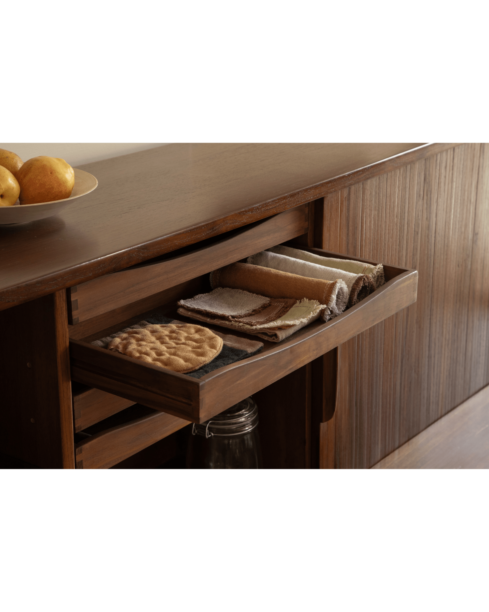 Ibu Teak Sideboard: Scandinavian style open drawer with folded napkins & textured woven mat.