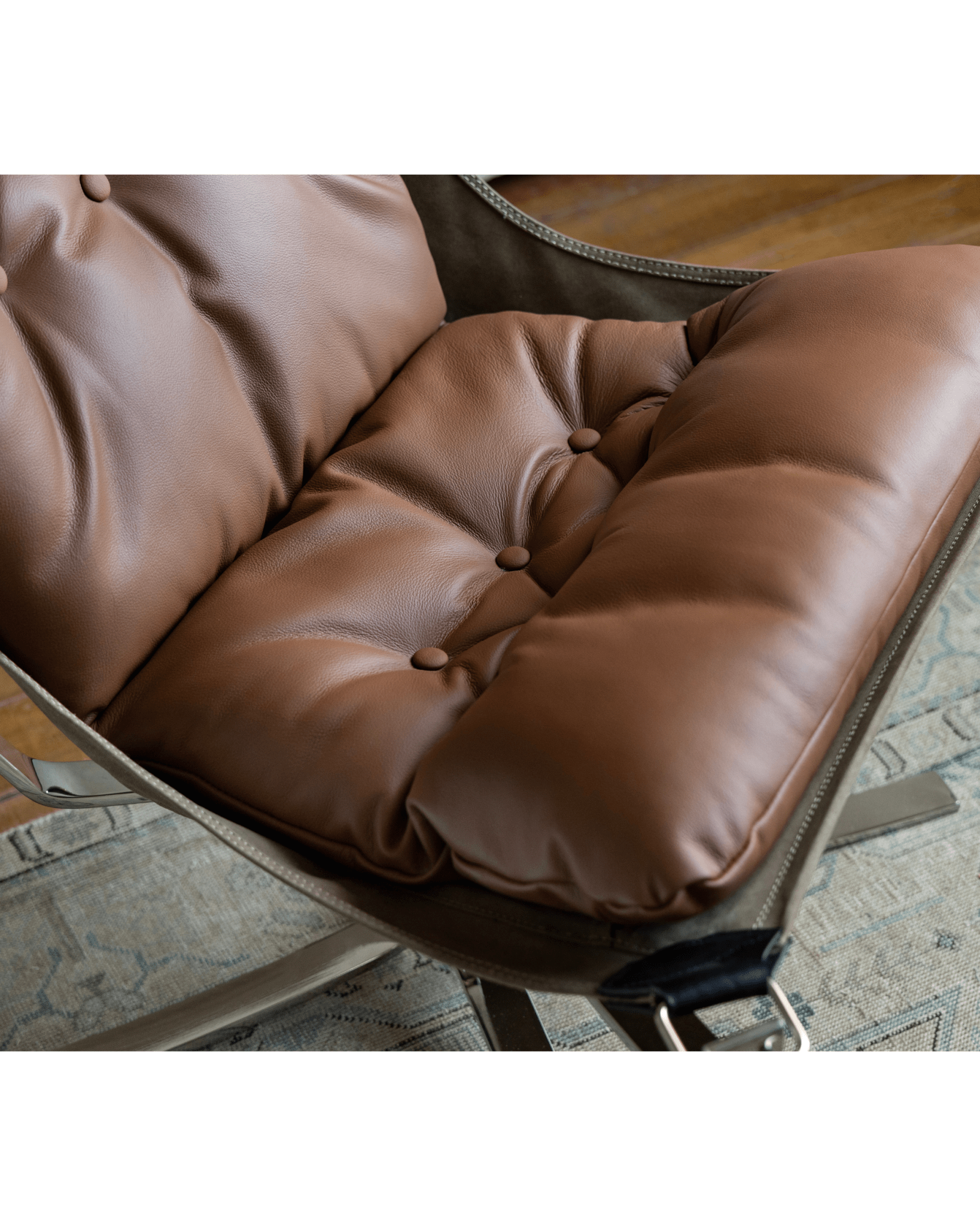 Falcon Chair detail: Brown leather cushion, button tufting, Scandinavian design, premium comfort, canvas frame