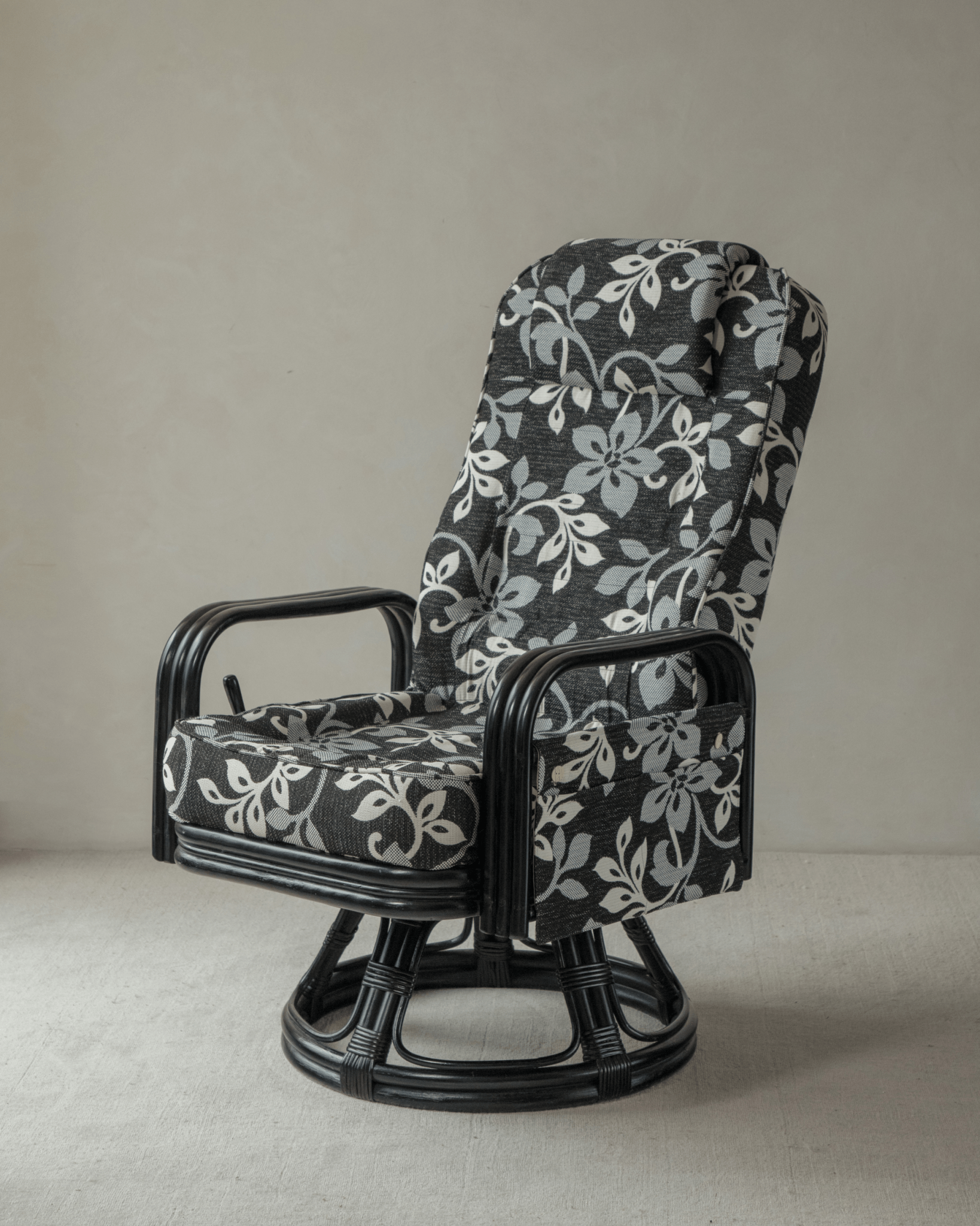 Willow Rattan Chair with black rattan frame and floral leaf pattern cushion