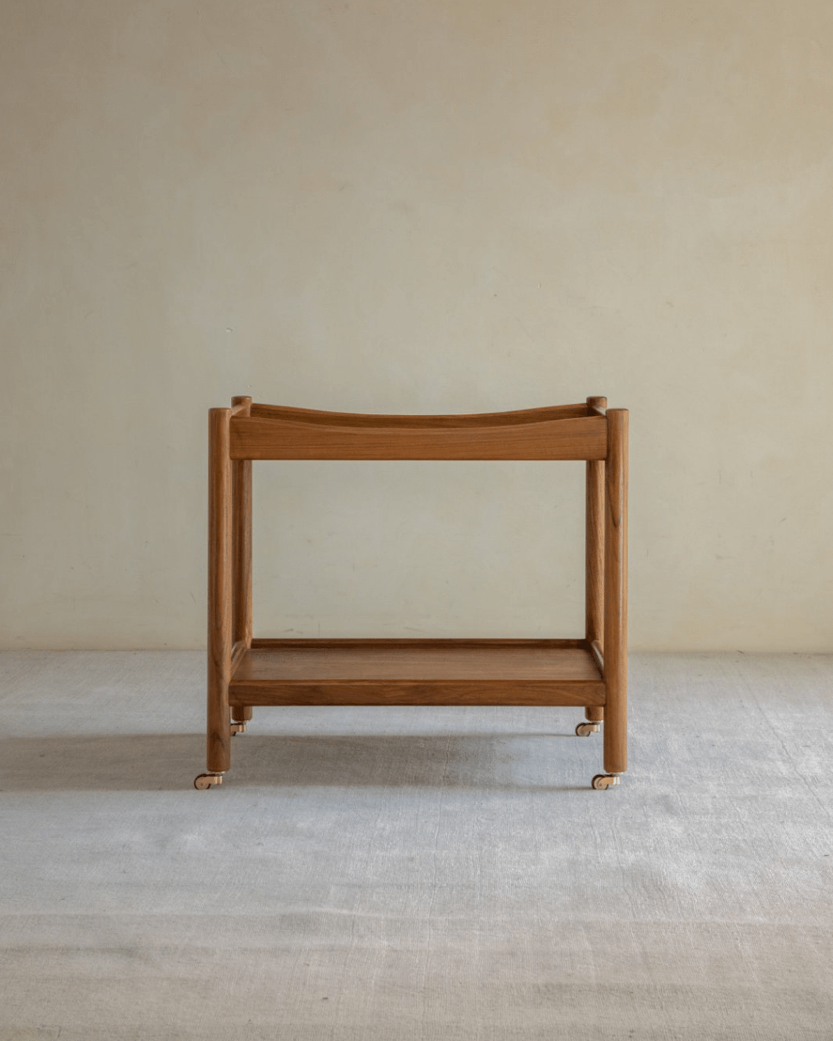 Brooklyn Bar Cart in natural wood finish, with double-layer storage, and brass caster wheels.