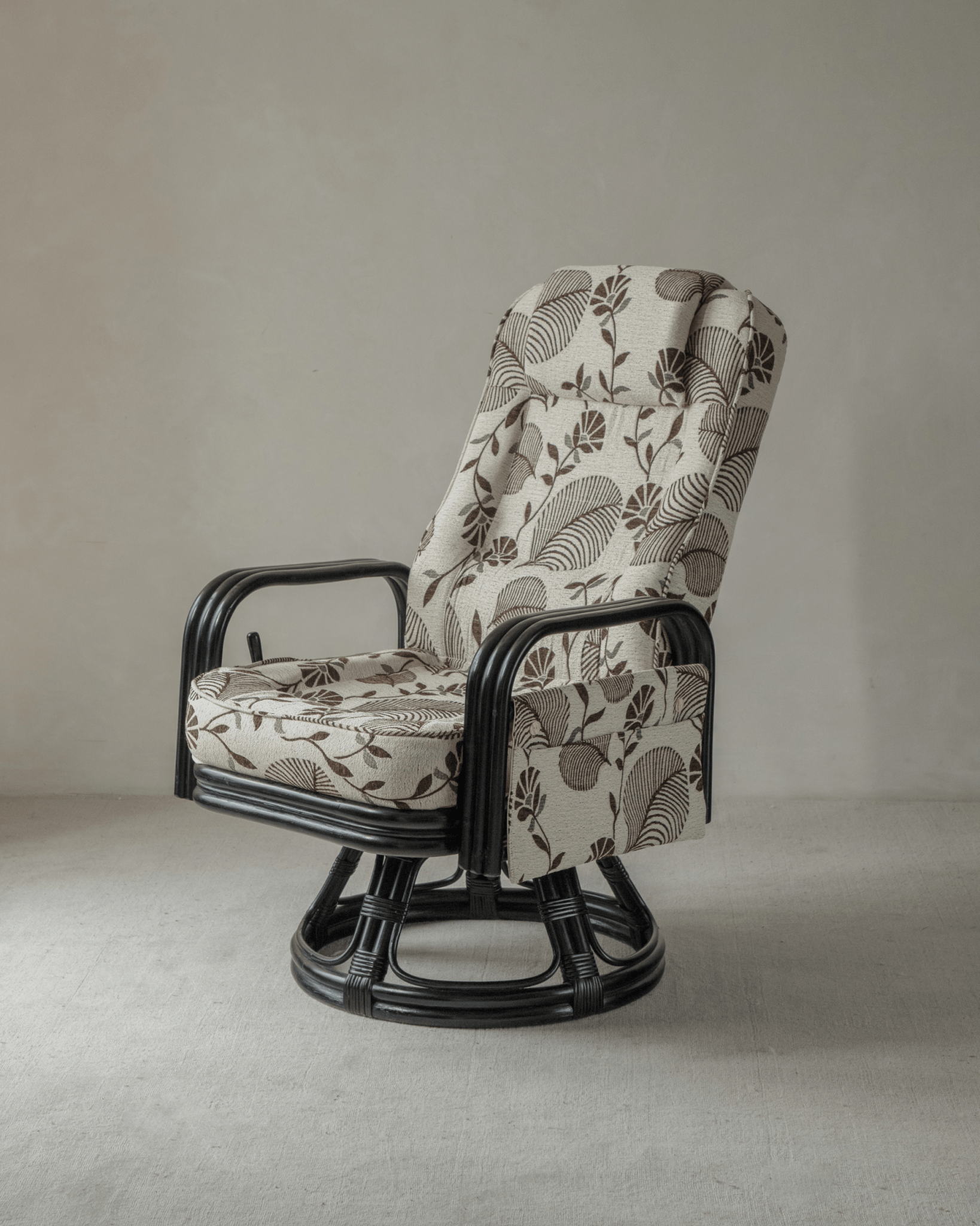 Willow Rattan Chair with floral cushions, black rattan frame and modern design, perfect for your living room.