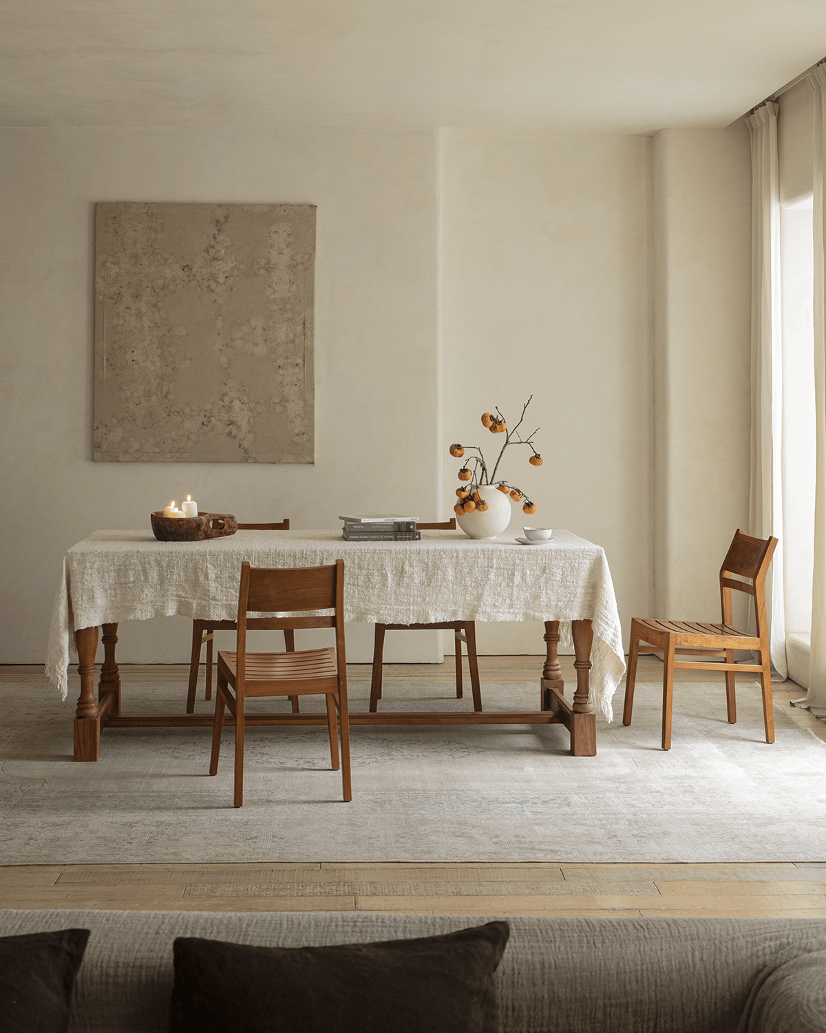 Beam Chair in a dining room setting. Teak wood chair with table and natural decor.