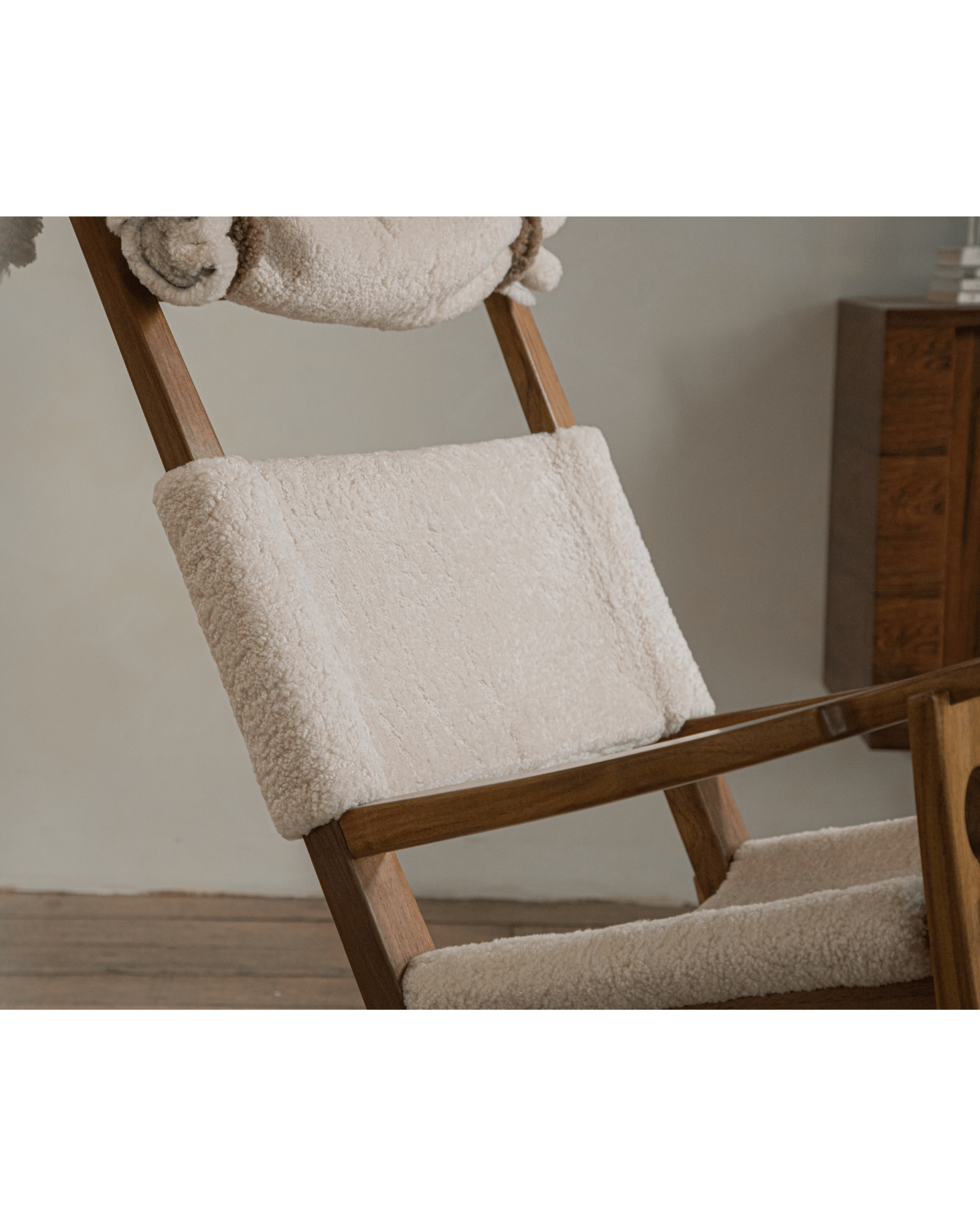 Hans Rocking Chair in Ivory Shearling - Danish design featuring a teak wood frame and plush shearling for cozy interior.