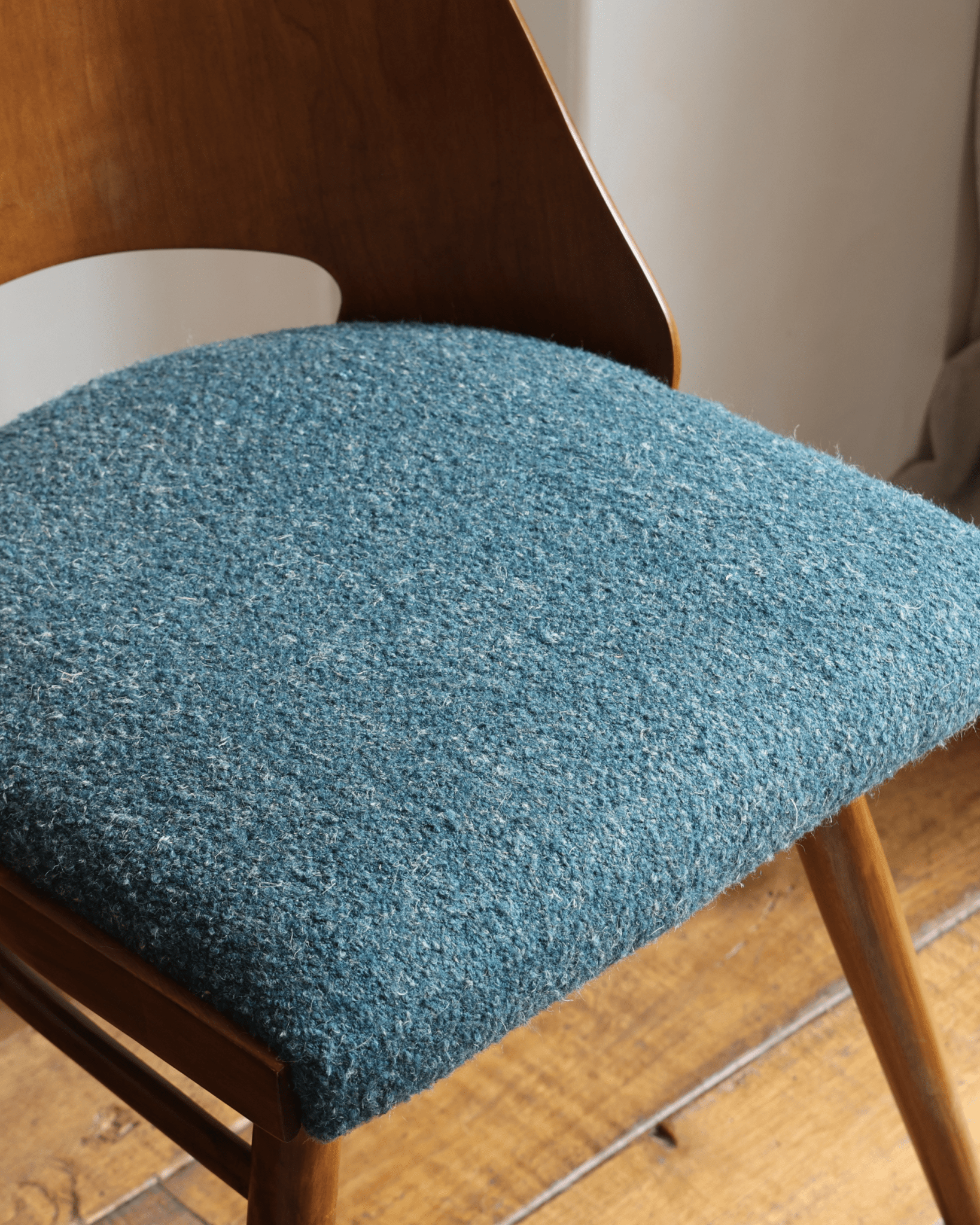 Shell Chair with teal loop fabric seat and teak wood frame, mid-century modern design