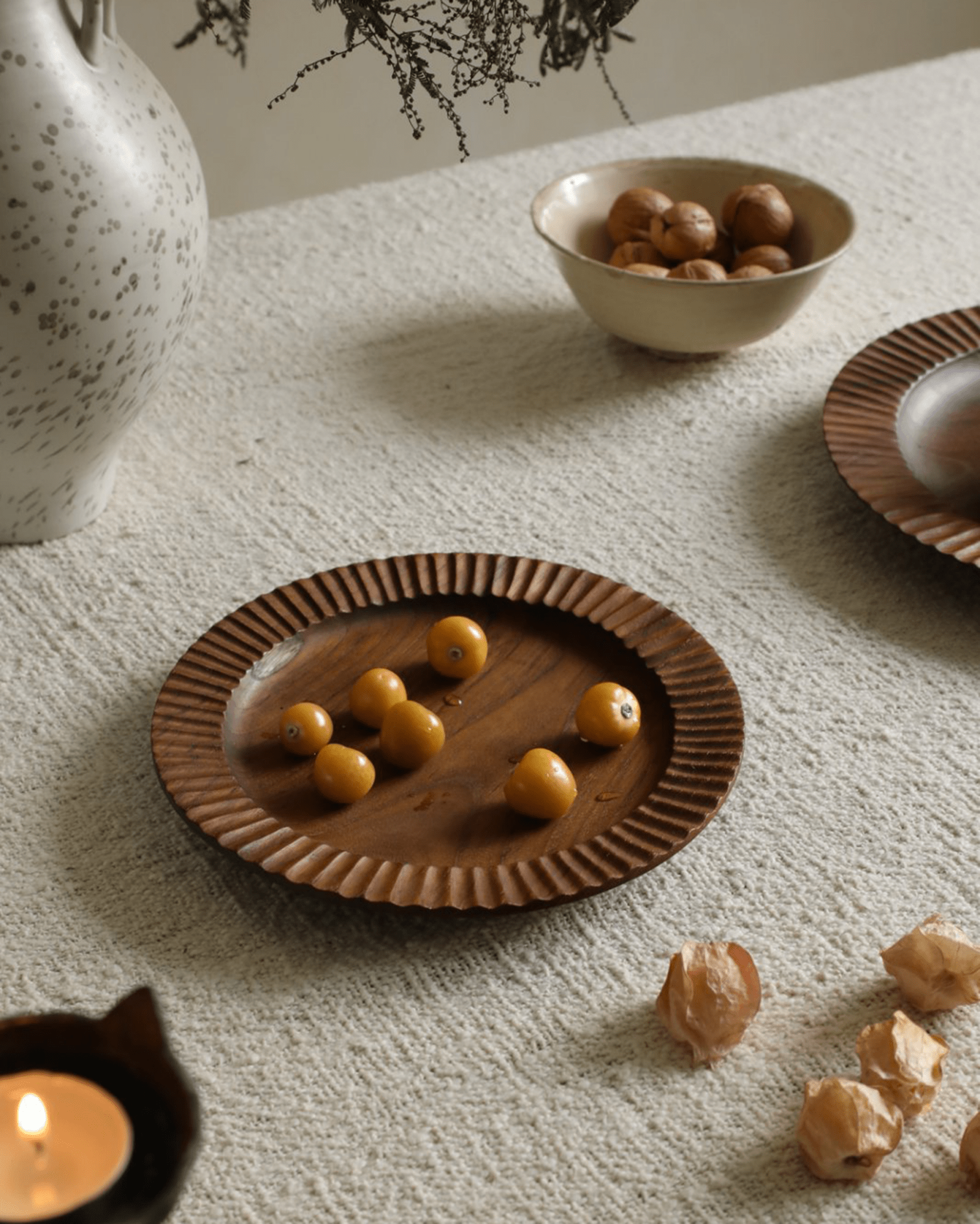 Handmade teak wood lace plate with yellow fruits, elegant Indonesian dining plate