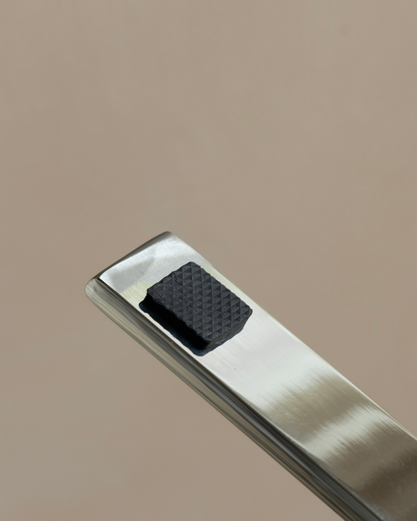 Falcon Chair detail: Brushed stainless steel frame and black foot, Scandinavian design