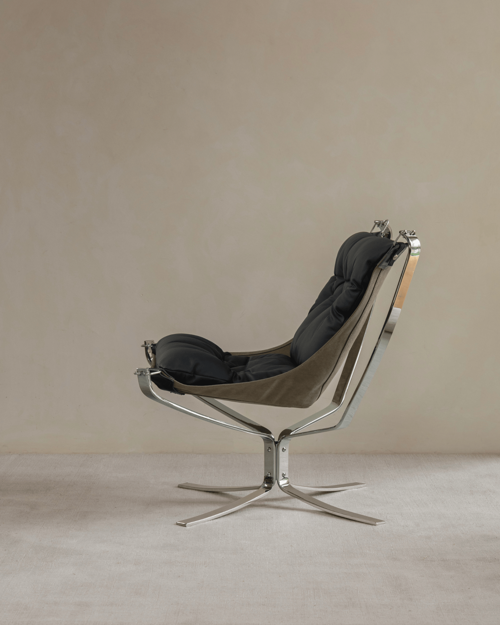 Falcon Chair in black leather with stainless steel frame, Scandinavian design, modern interior comfort