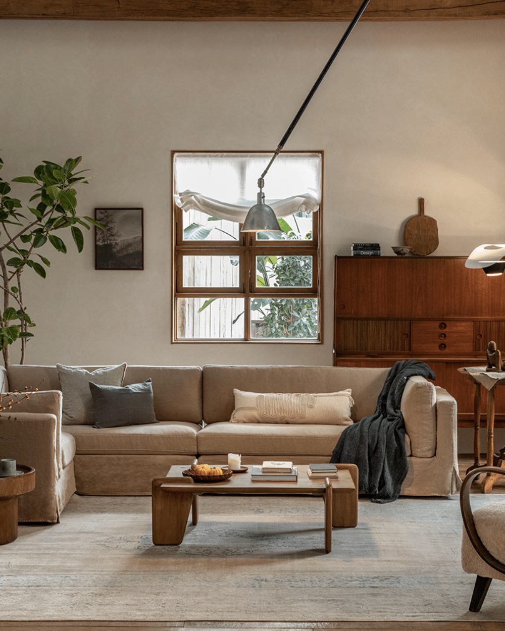 Beige linen skirt sectional sofa in a modern living room setting.