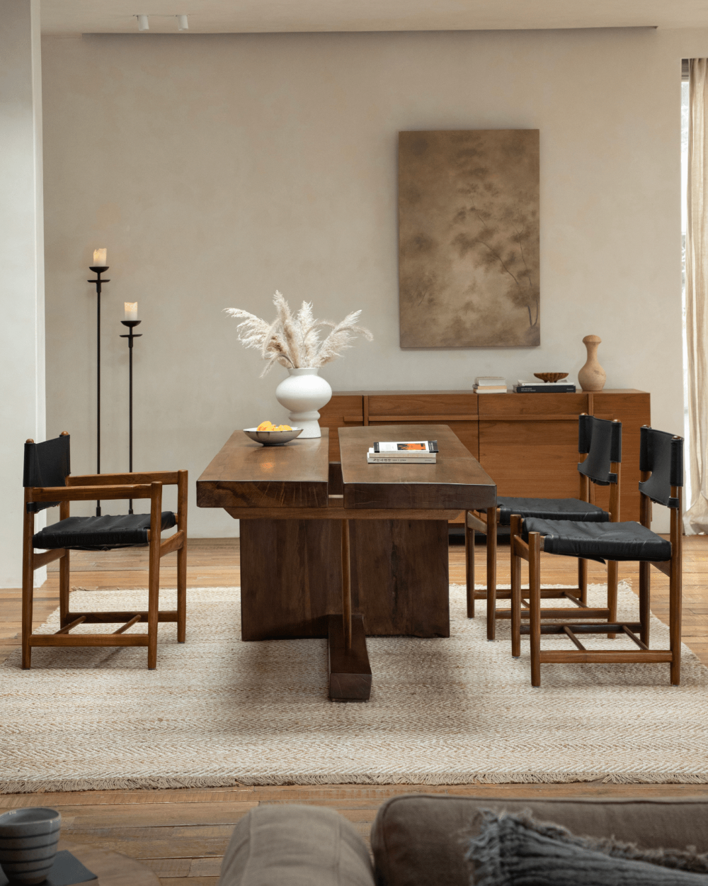 Solid wood dining table in modern setting, featuring wooden chairs and elegant decor