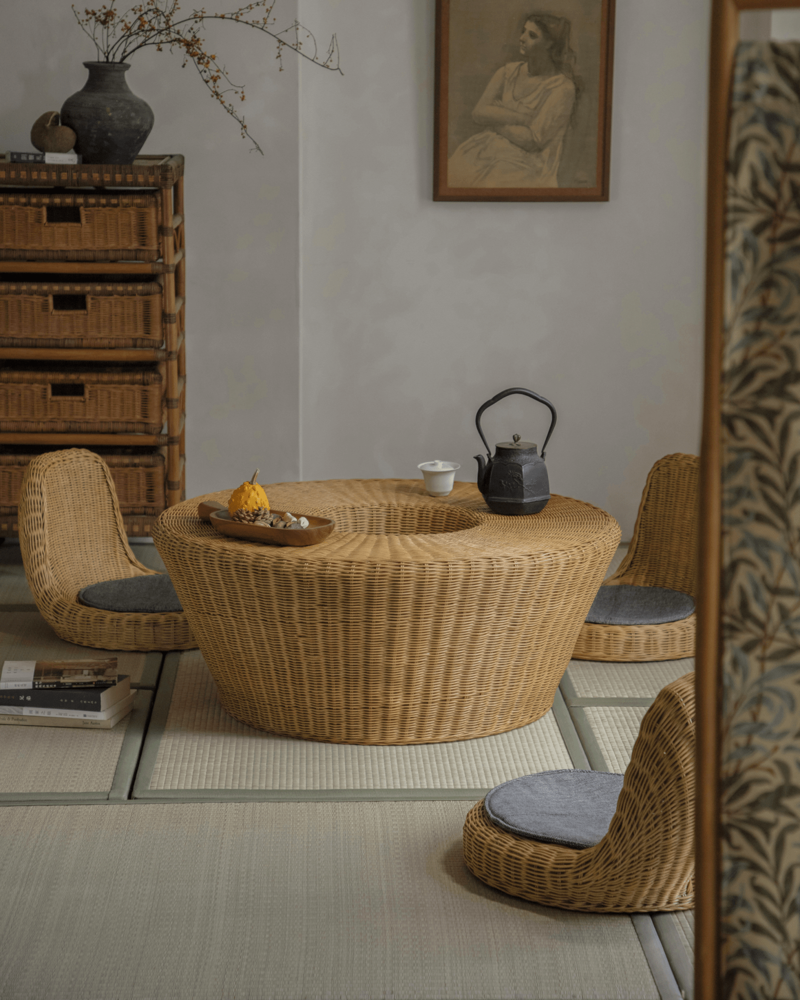 Nest Coffee Table in a serene living room, rattan table and chairs with sunken design, creating a stylish space.