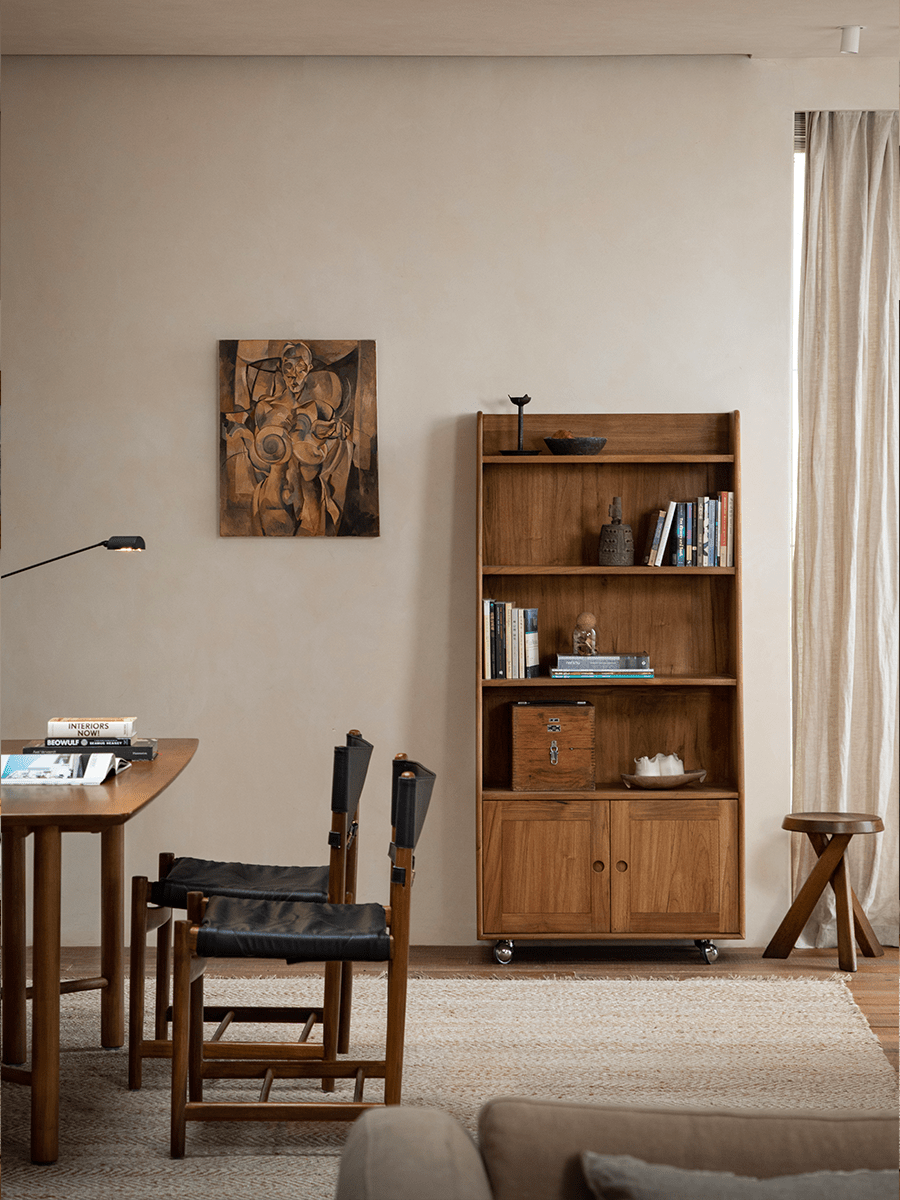Lidi Display Cabinet in a modern living room, showcasing teak wood, adjustable shelves, and wheels