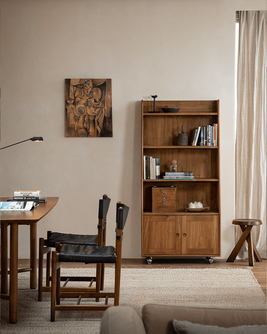 Lidi Display Cabinet in a modern living room, showcasing teak wood, adjustable shelves, and wheels