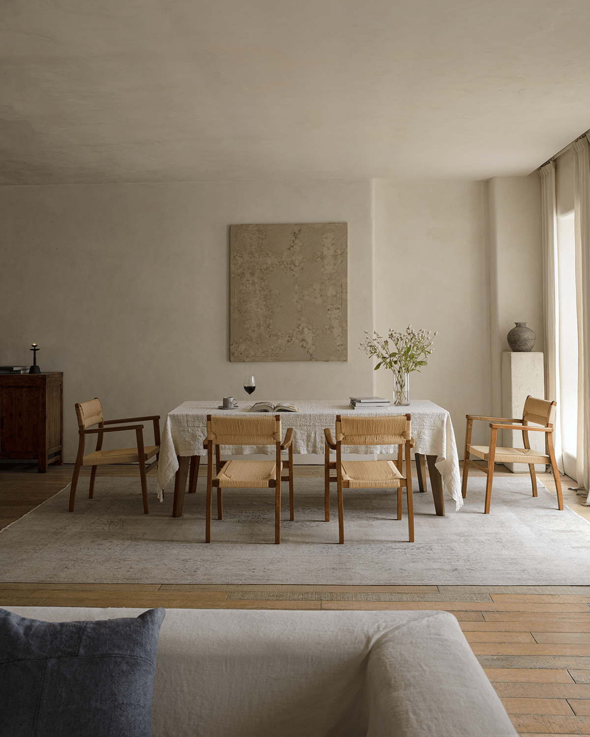Reed Chairs in a dining room setting with teak frame and woven seat, offering a stylish and comfortable seating option.