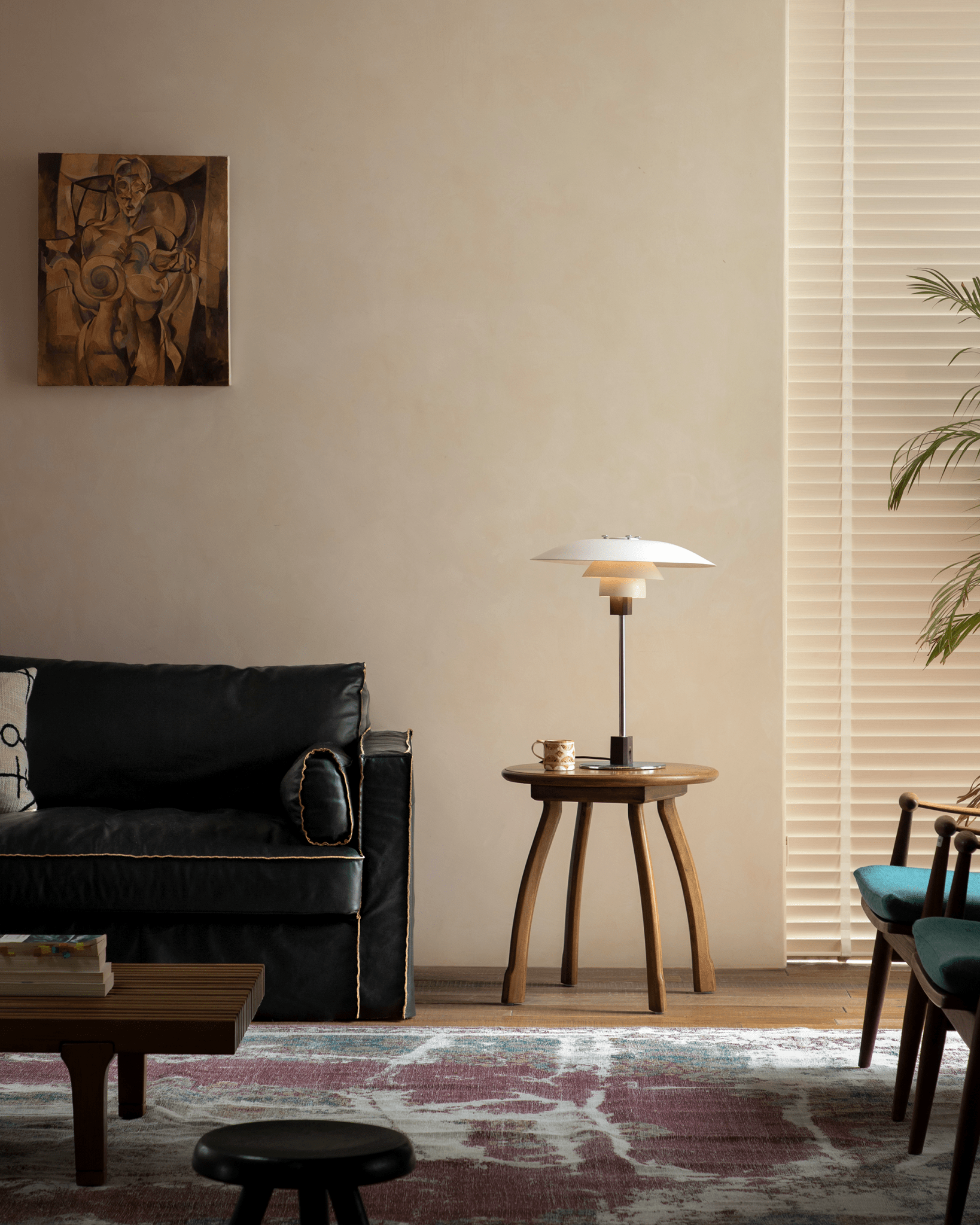 Ele Round Side Table, vintage design with octopus legs, Phoebe wood, and lamp in cozy interior setting.