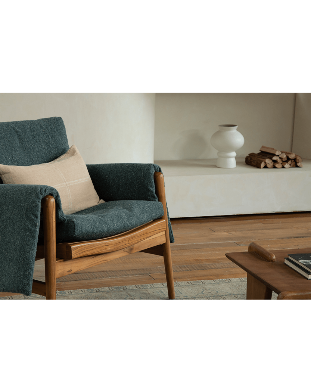 Teak wood garden lounge chair with dark teal cushion and throw, indoor comfort, wooden frame, stylish interior
