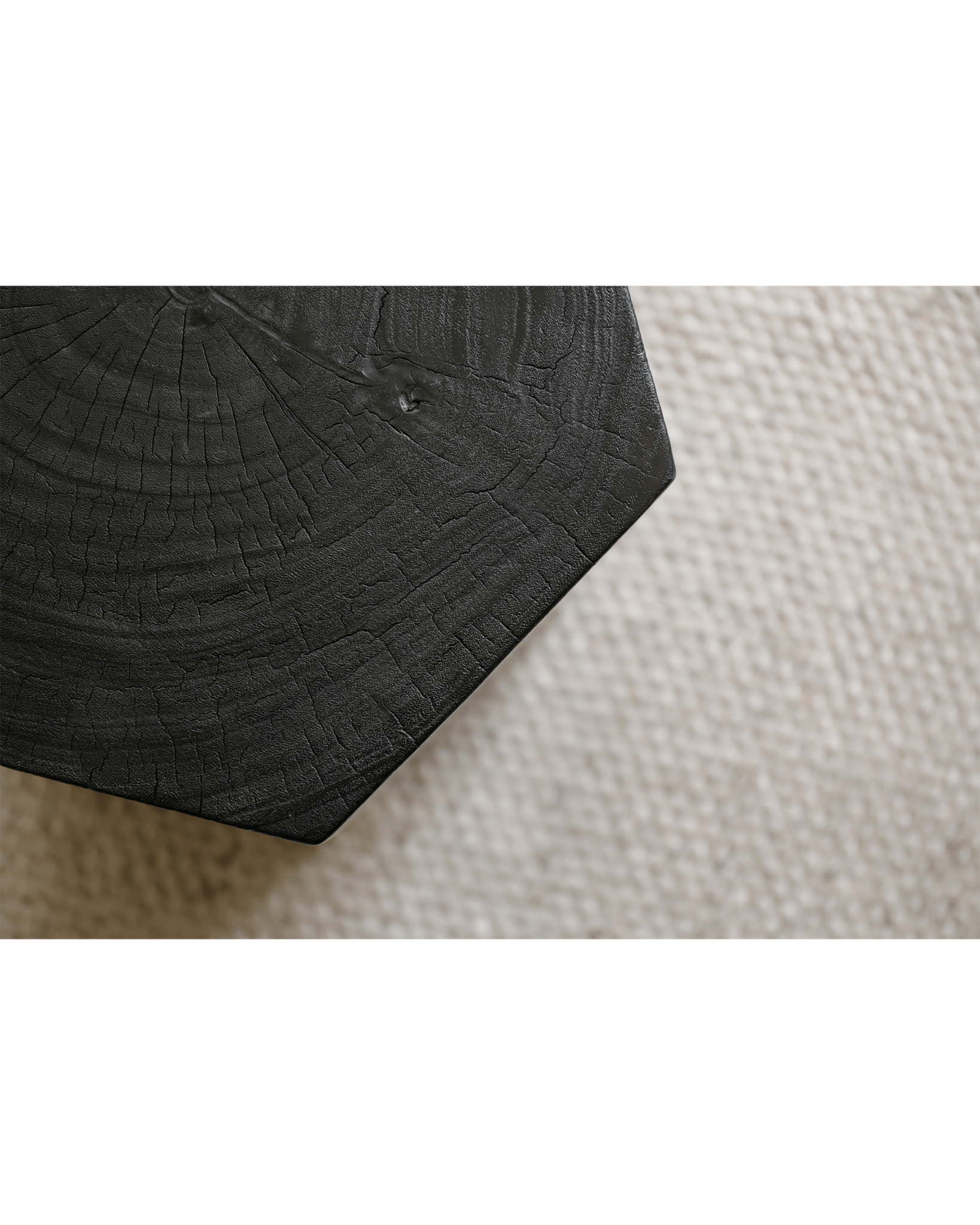 Hexagon Side Table close-up: carbon-black finish, geometric design, and natural wood grain texture, versatile accent piece.