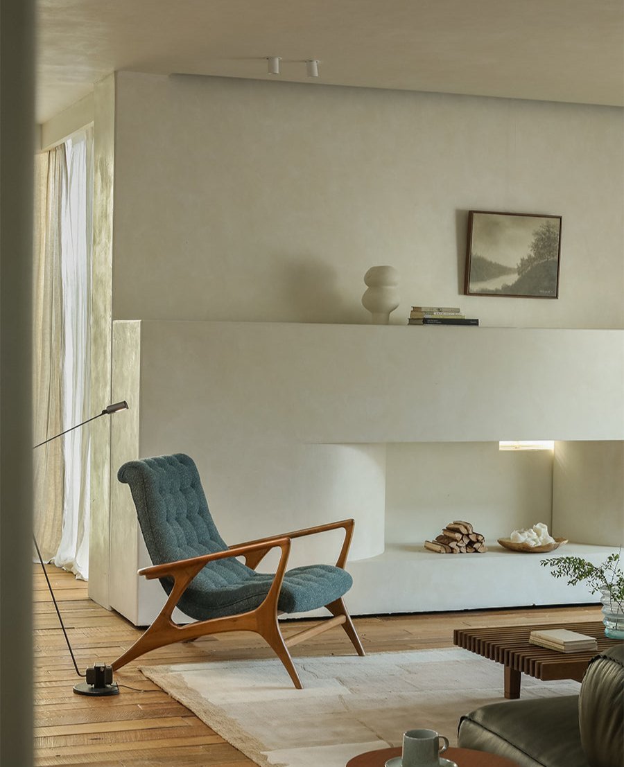 Teal bouclé Kagan Lounge Chair in a modern living room with solid teak wood frame and comfortable design