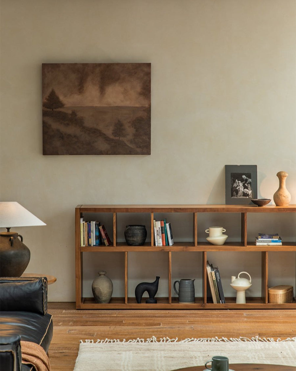 Tome Bookcase in a living room, solid wood, multiple compartments, books and decor, cozy interior design