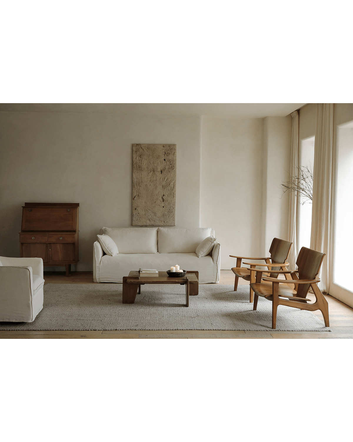 Zen Armchair in minimalist living room, ergonomic design, wooden construction, and emphasis on relaxation and comfort.