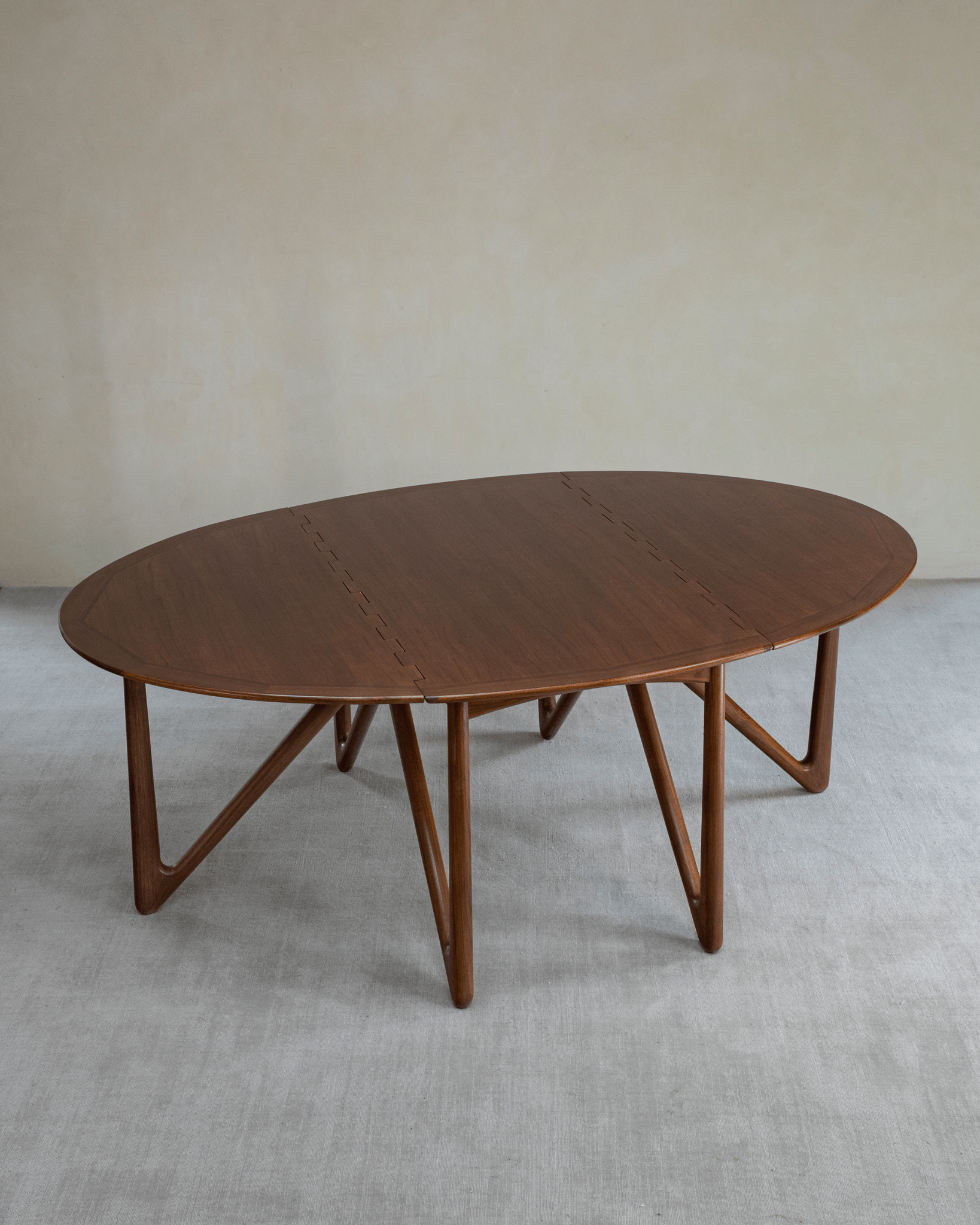 Niels Folding Table, teak wood, extended oval shape, mid-century modern design with V-shaped legs