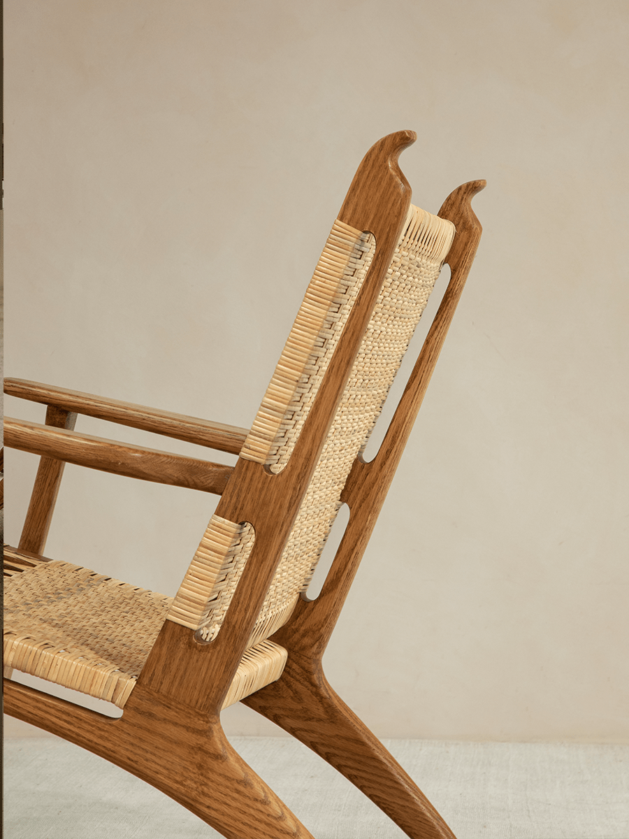 Horn Lounge Chair detail: oak frame, natural rattan seat and backrest, ergonomic design, perfect for interior decor.