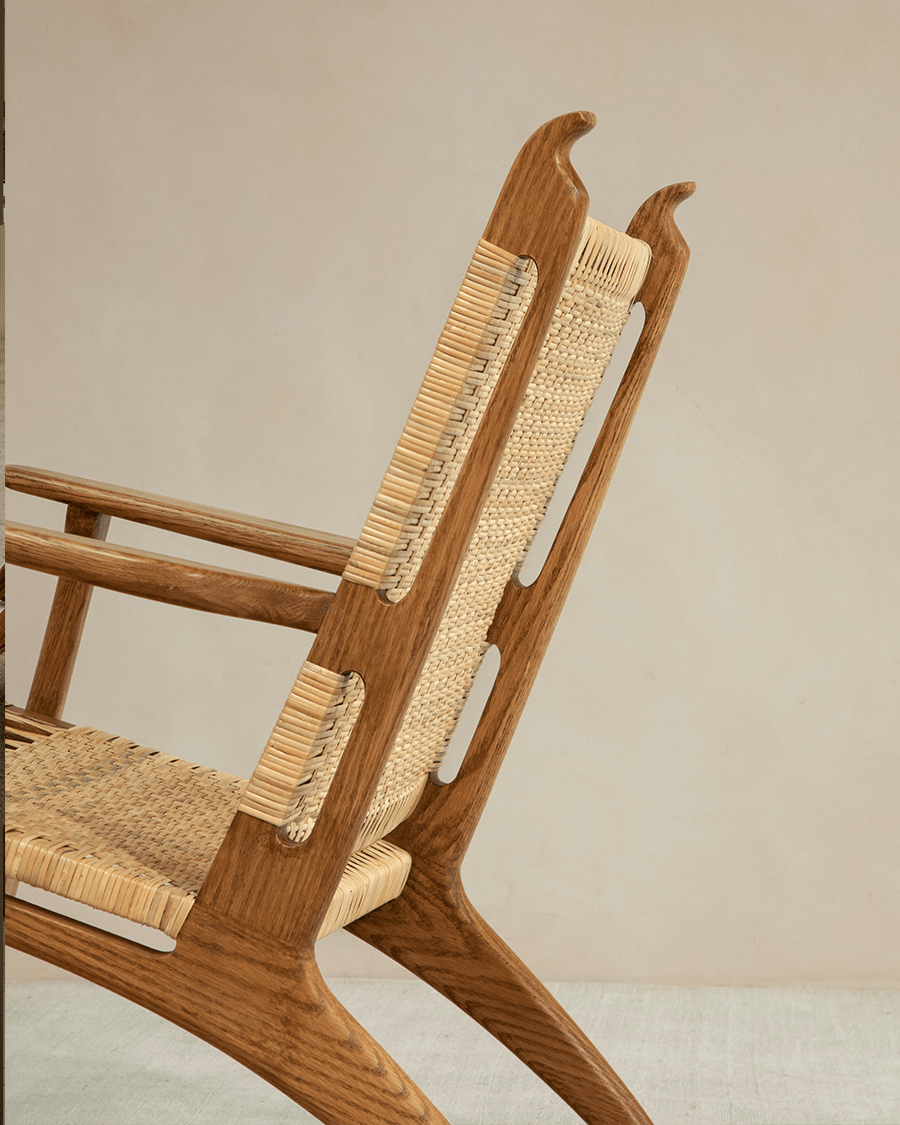 Horn Lounge Chair detail: oak frame, natural rattan seat and backrest, ergonomic design, perfect for interior decor.