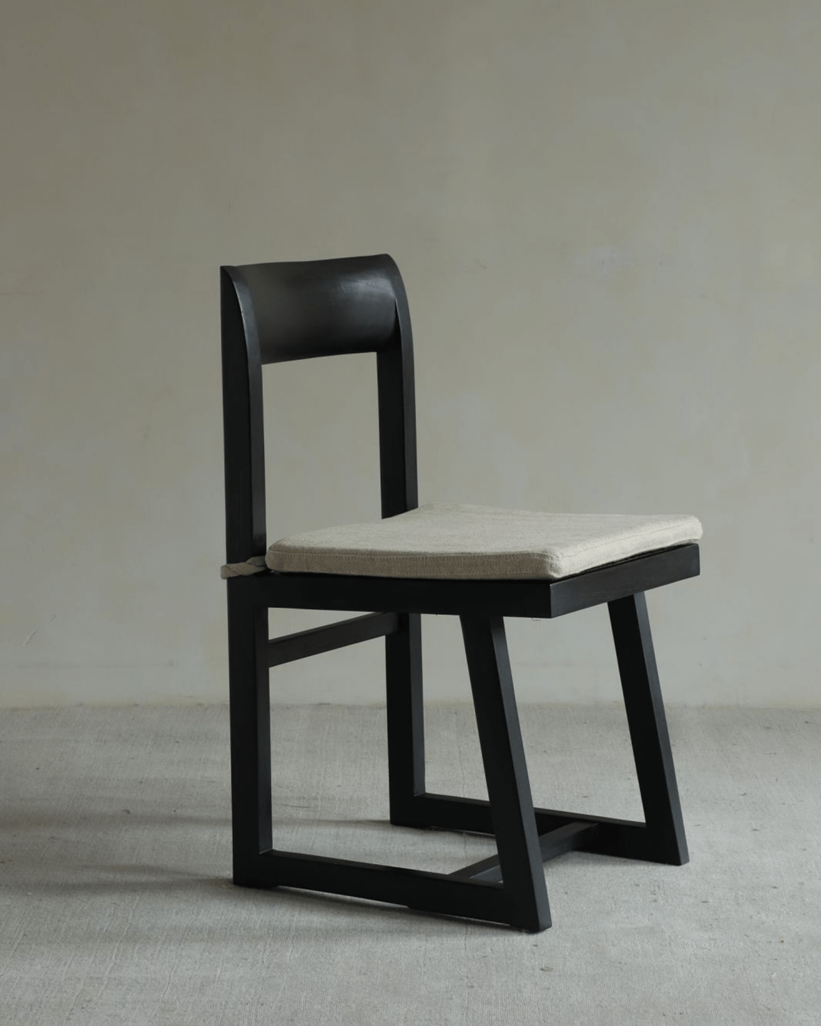 Chandigarh Box Chair with black wooden frame and fabric seat cushion. Mid-Century Modern design