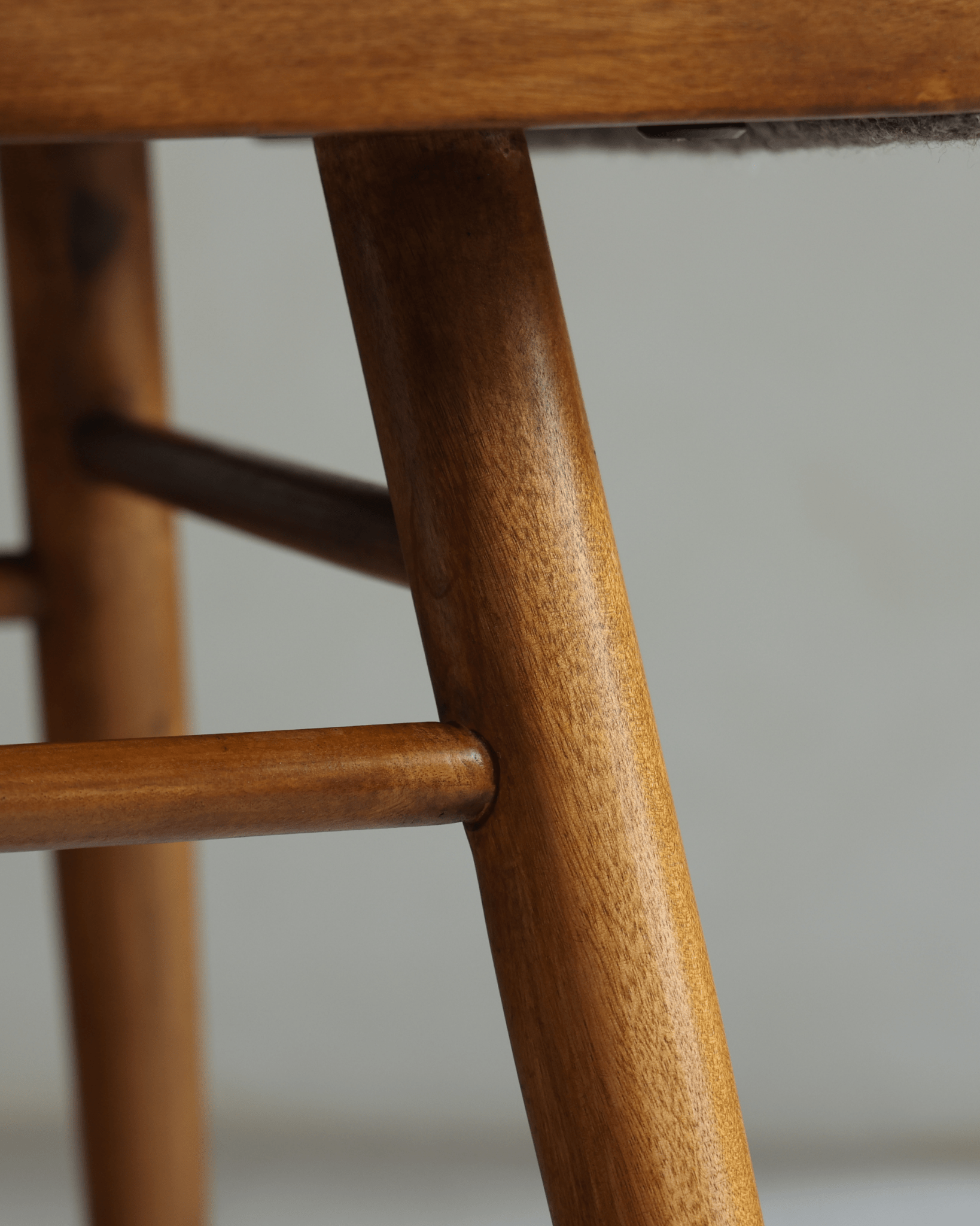 Shell Chair close-up: Teak wood frame details, mid-century modern design