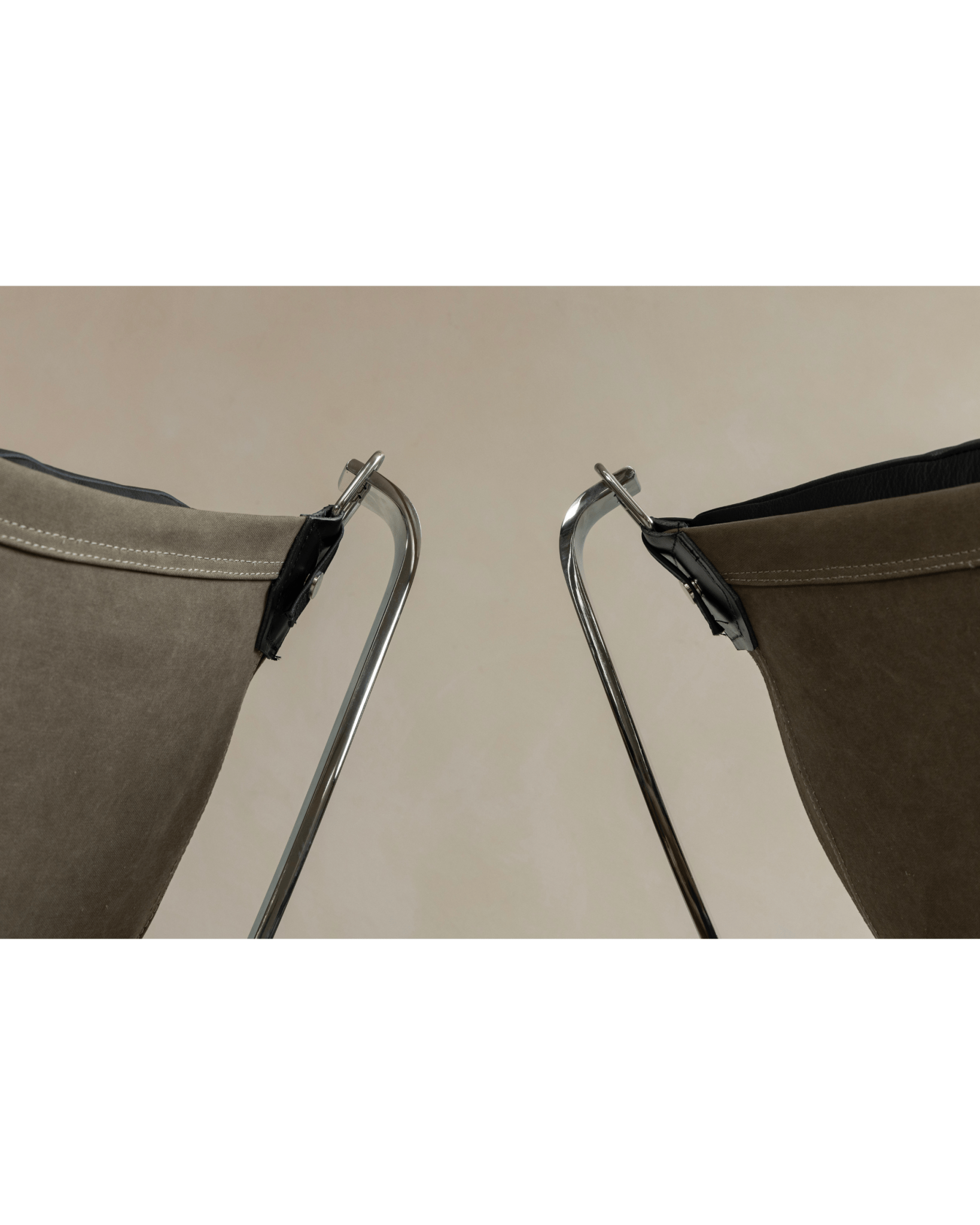 Falcon Chair detail: Olive green canvas, black leather accent, stainless steel frame, Scandinavian design.