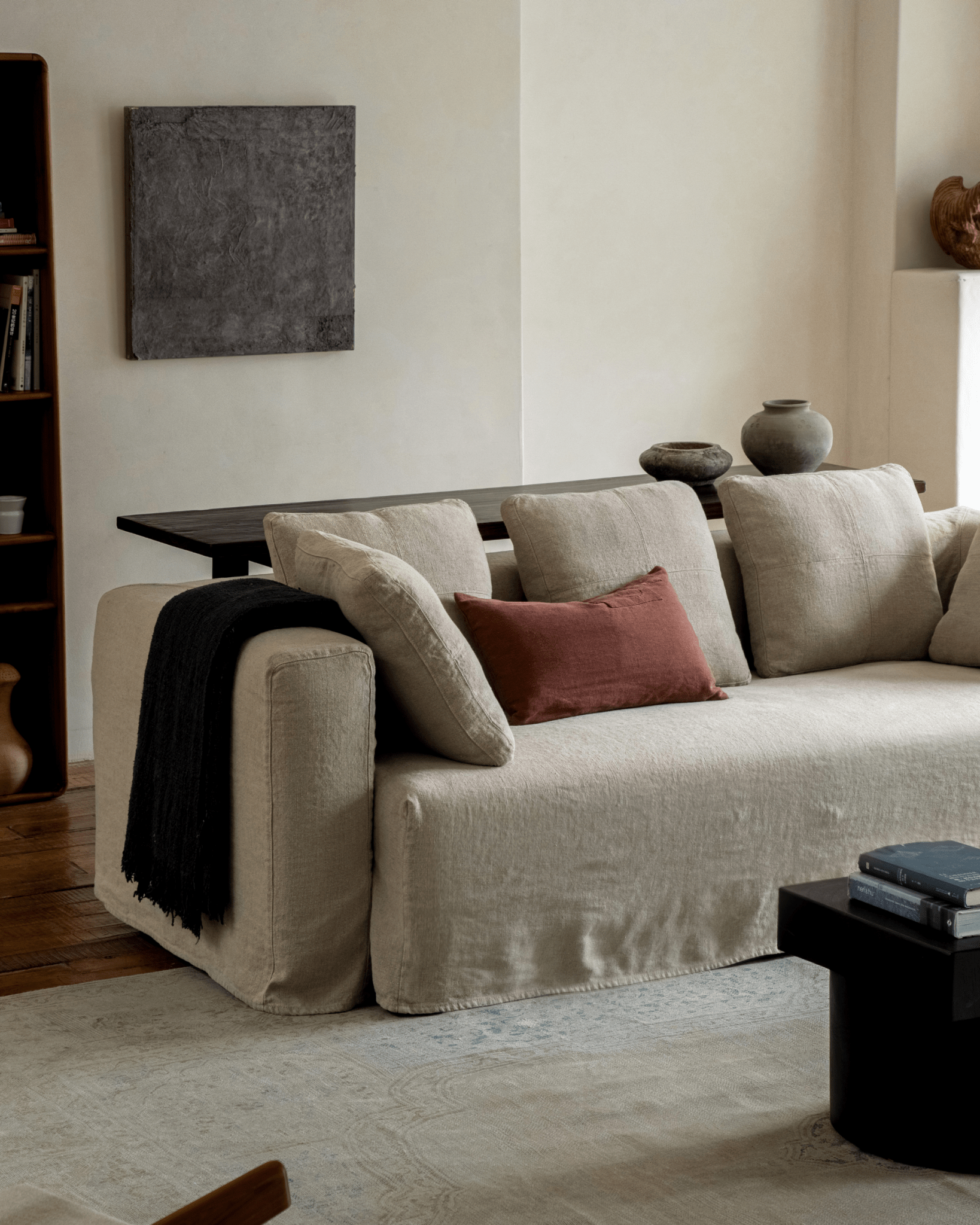 Nola Sofa in natural linen, stylish design with comfortable cushions, and a welcoming living room setup.