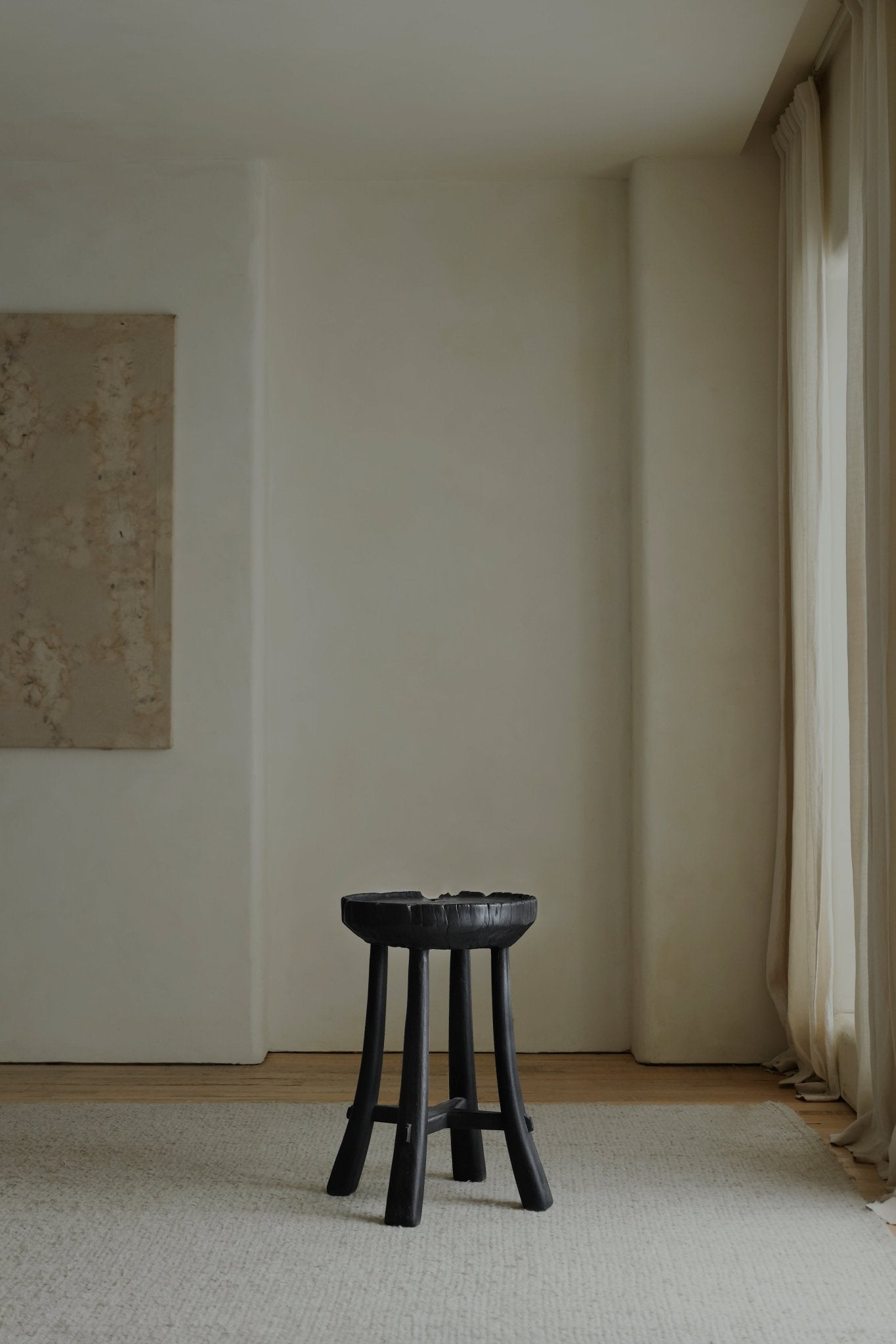 Basin Side Table - Black wooden stool with carved top and angled legs, modern living room decor