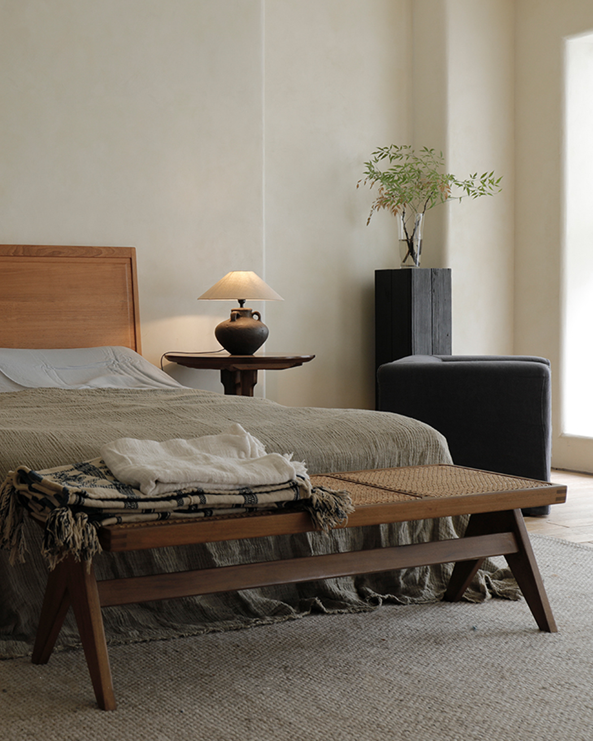 Chandigarh Bench in a bedroom setting, teak wood and natural rattan mid-century modern design