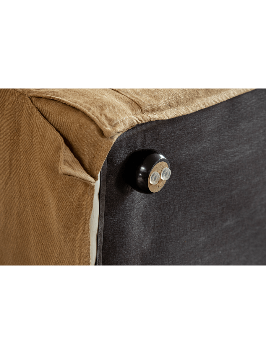 Skirt Linen Sofa detail with tan linen fabric and dark base, showcasing the modern design and materials