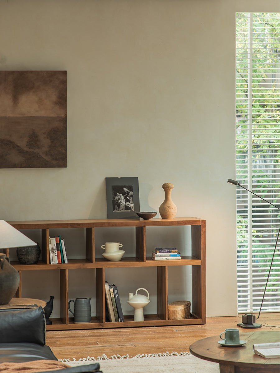 Tome Bookcase styled in a living room, solid wood with multiple compartments, showcasing books, decor and a cozy interior.
