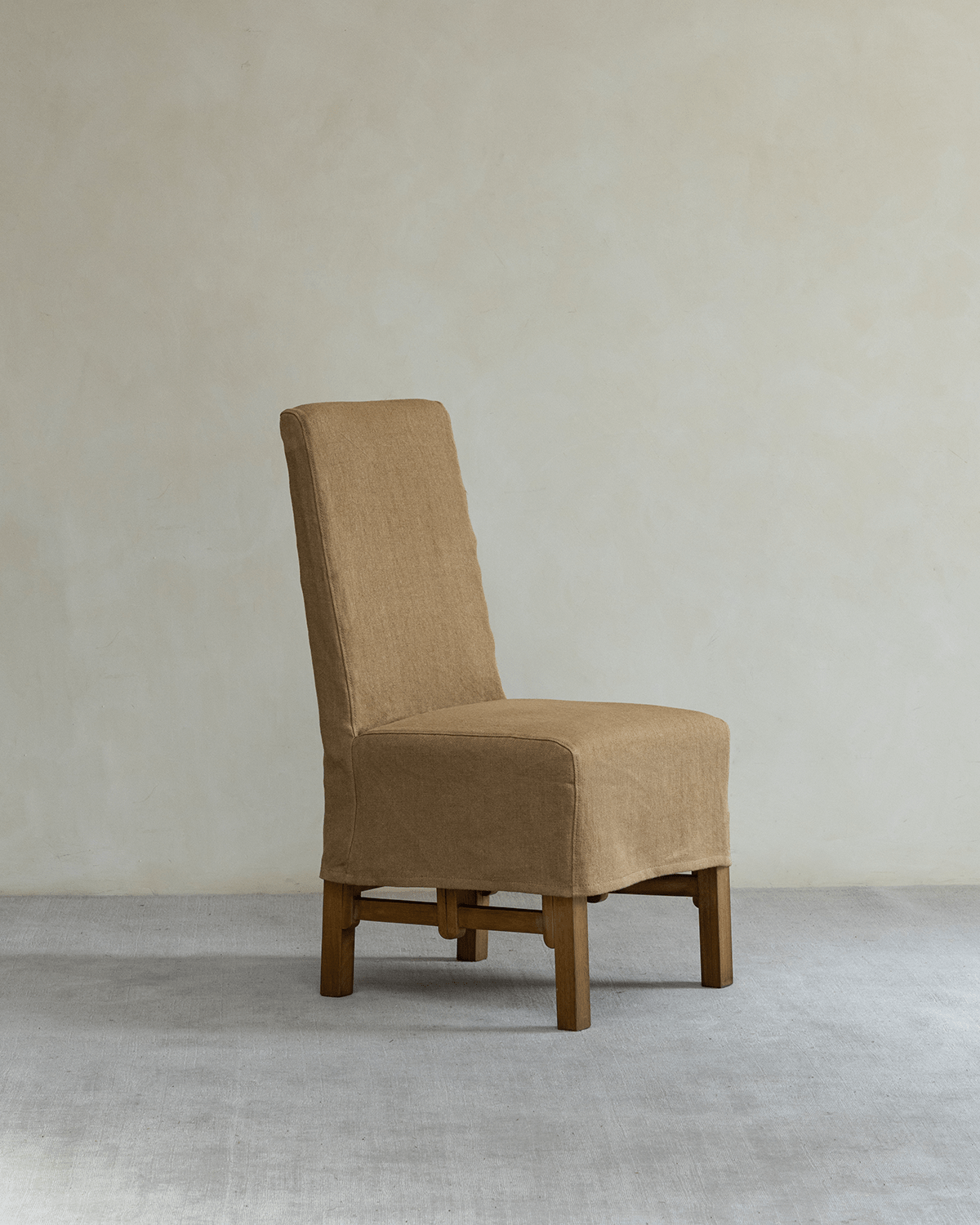 Feast Dining Chair with tan linen slipcover and wooden frame